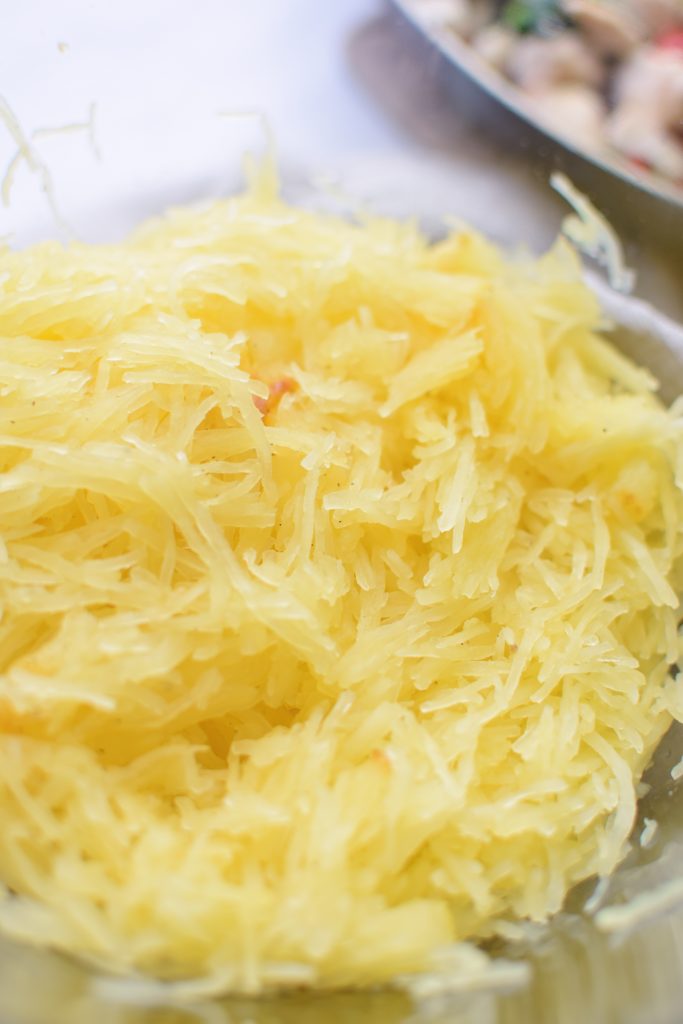 shredded spaghetti squash noodles in a glass bowl.