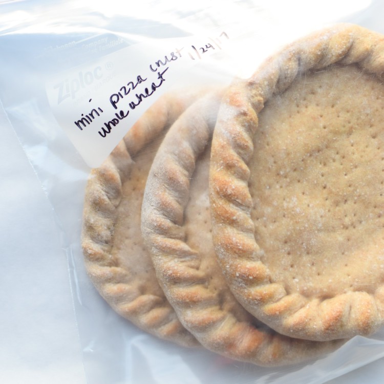 How To Make Trader Joe's Pizza Dough Into Freezer Friendly Premade Pizza Crusts - Four mini pizza crusts in the freezer for emergencies!! Using SUPER cheap Trader Joe's dough! - ProjectMealPlan.com