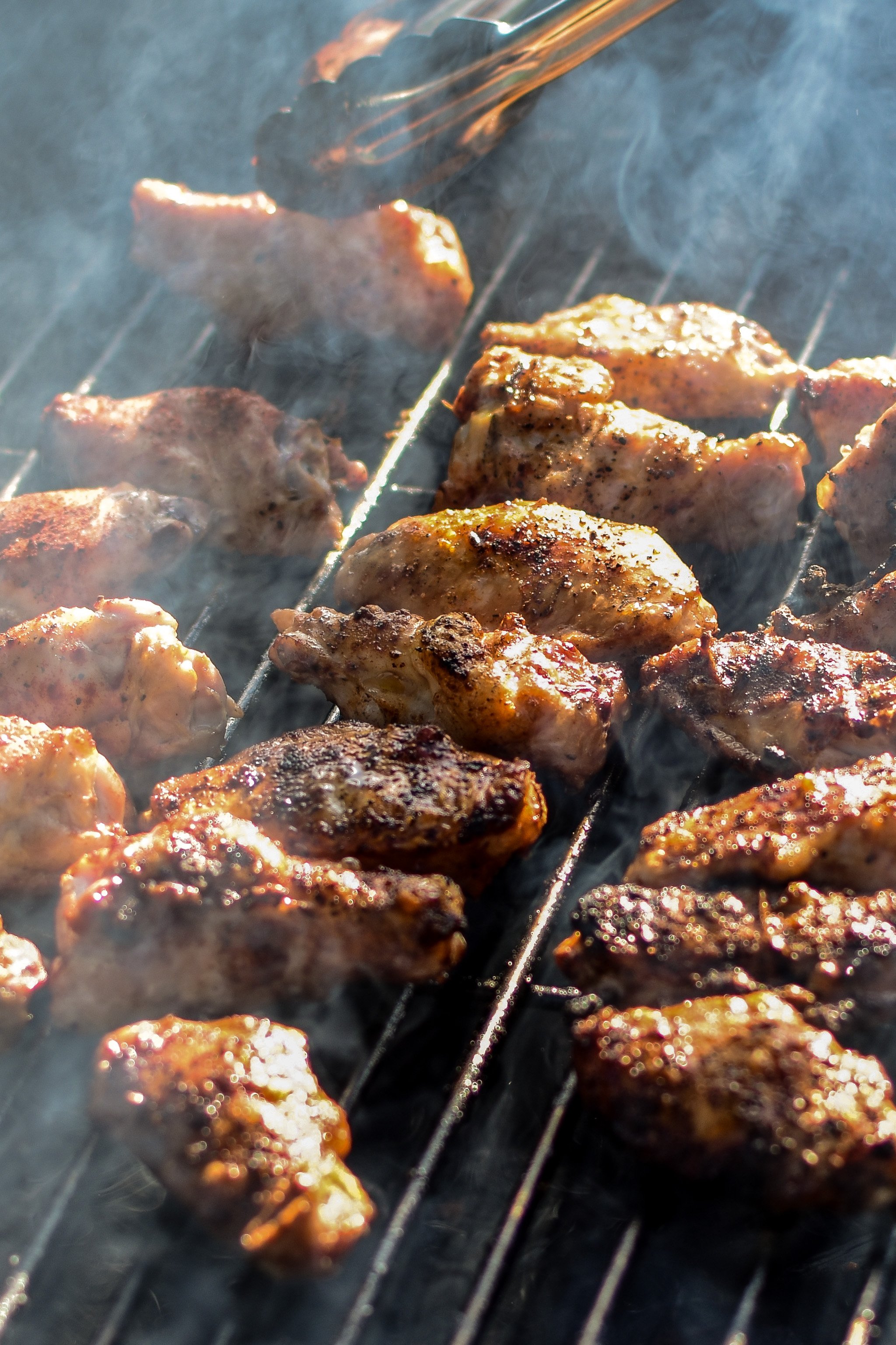 Grilling chicken wings in the sunshine for the Smoky Habanero Barbecue Grilled Chicken Wings
