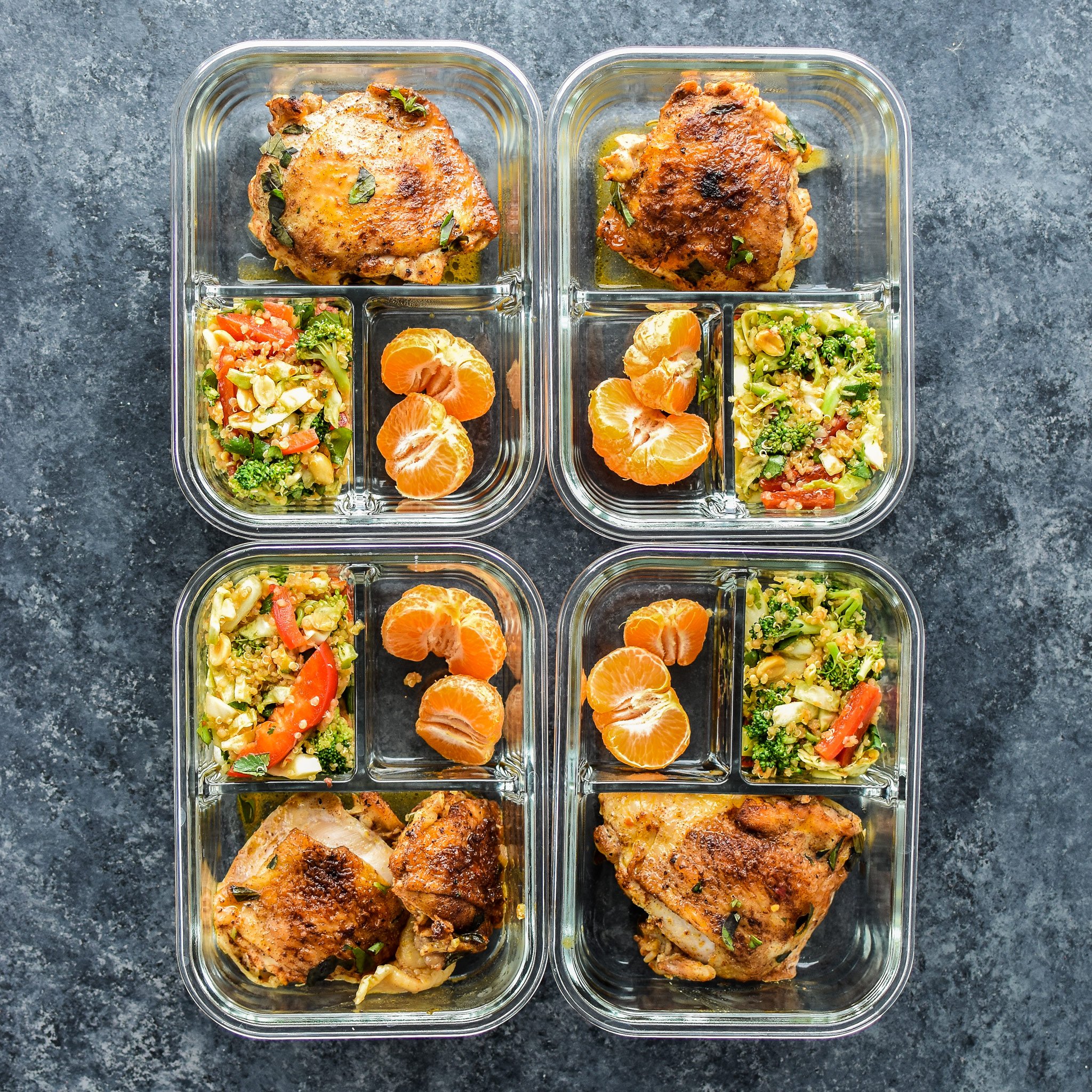 Meal prepped chicken thighs with asian quinoa salad and mandarins.