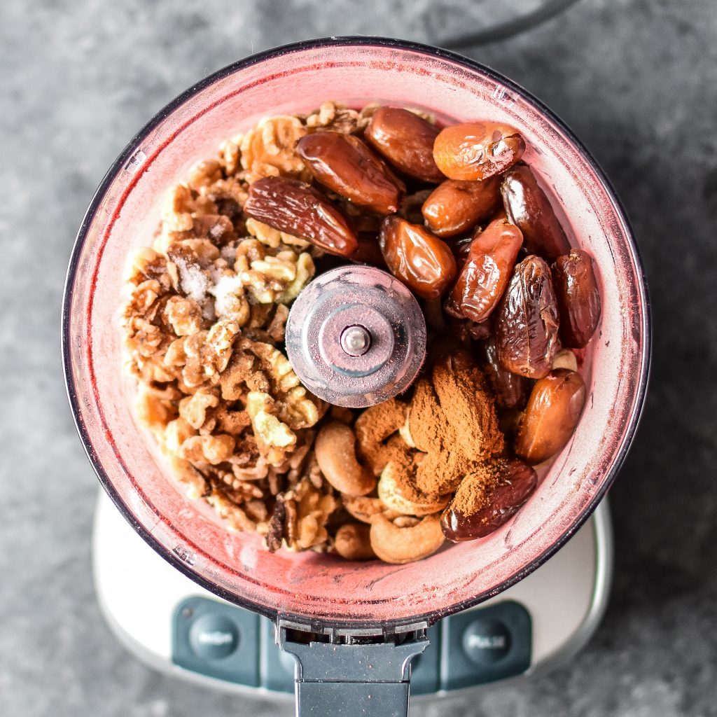 ingredients in a food processor to make bliss balls before blending.