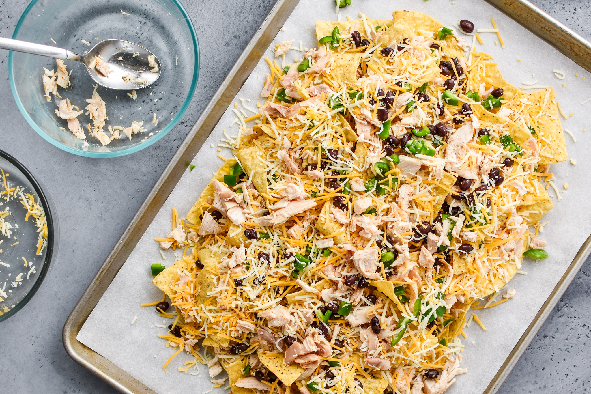 The prep ahead rotisserie chicken nachos before they go in the oven.