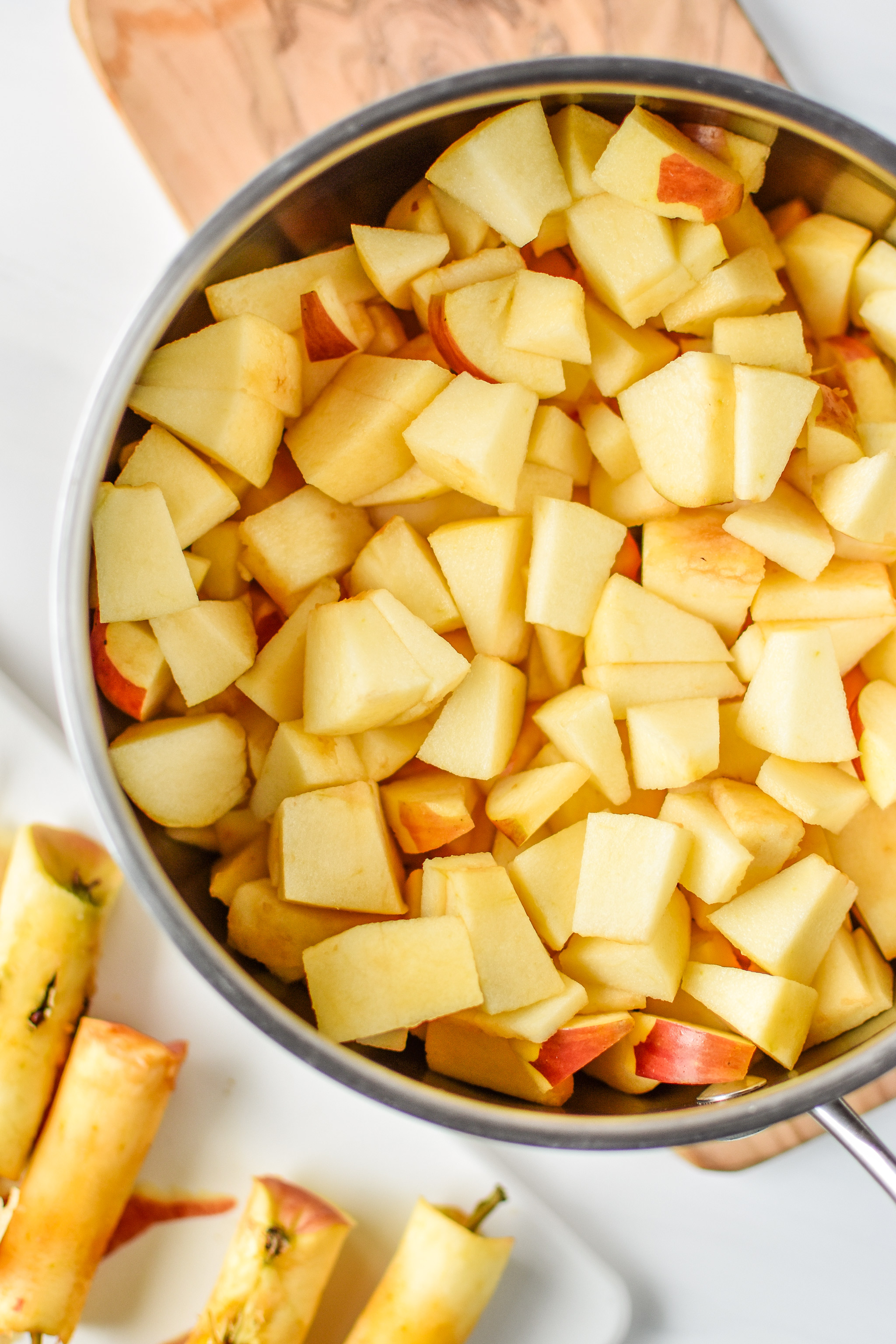 Apples cut and peeled in the pan ready to be cooked down into applesauce. Store bought vs Homemade: Which is Cheaper?