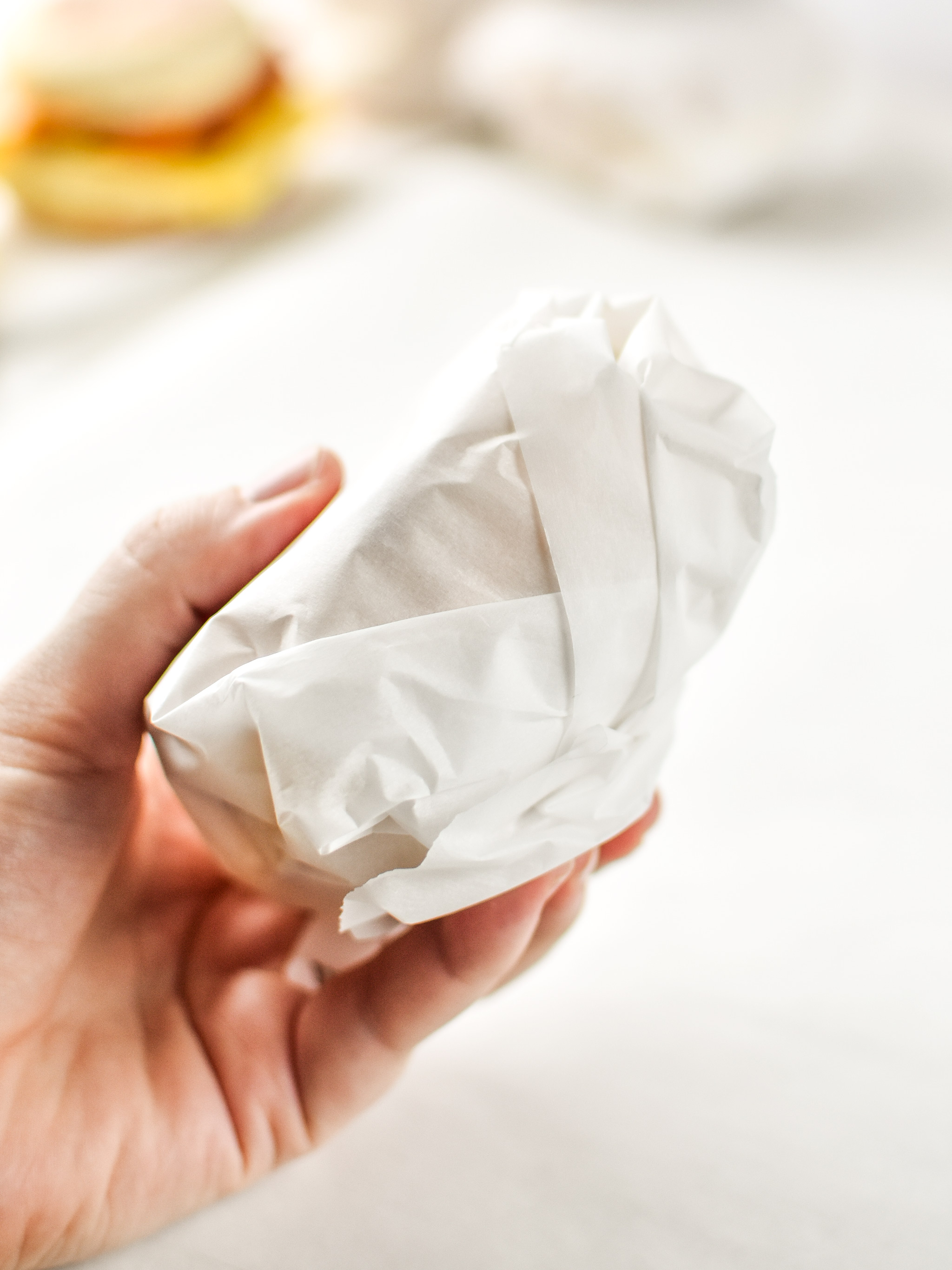 A wrapped make-ahead bacon breakfast sandwich.