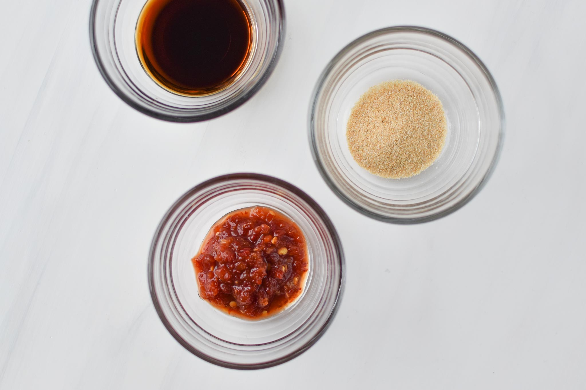 Libbey glass prep bowls with spices and sauces.