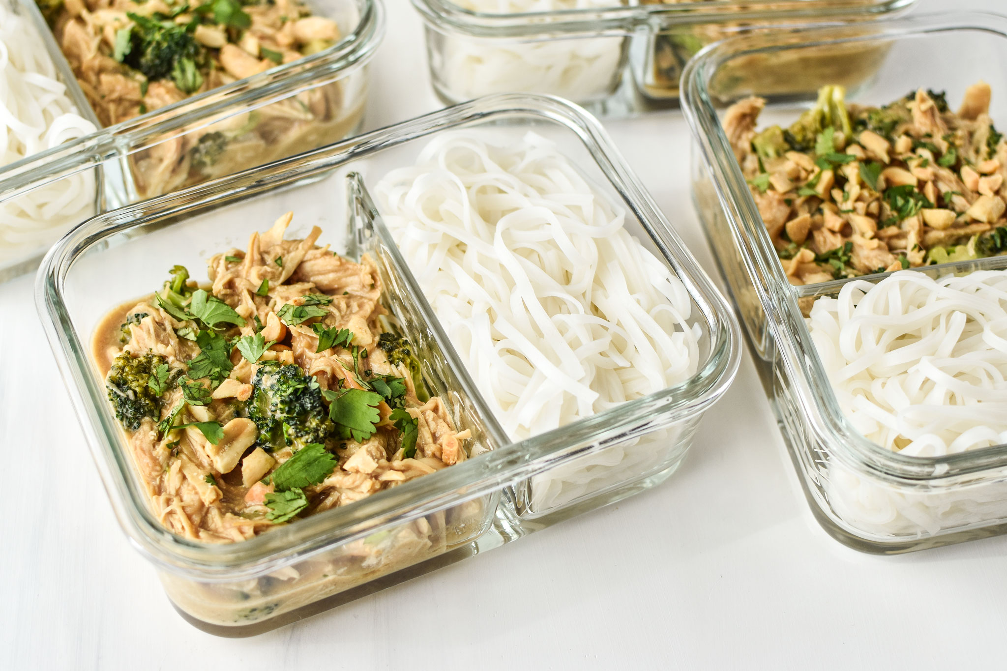 slow cooker peanut chicken noodle meal prep pictured in glass meal prep containers