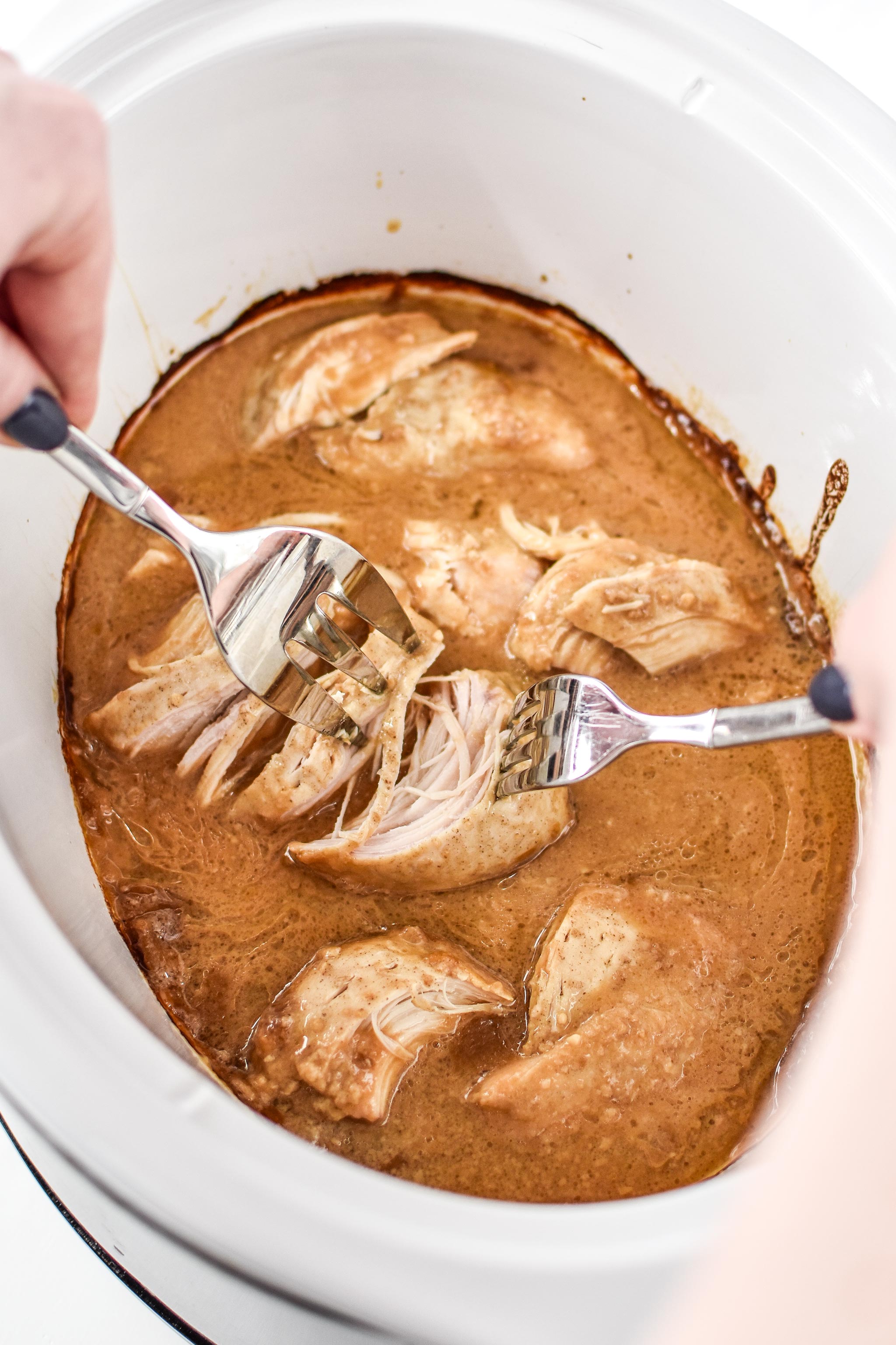 shredding the slow cooker peanut chicken