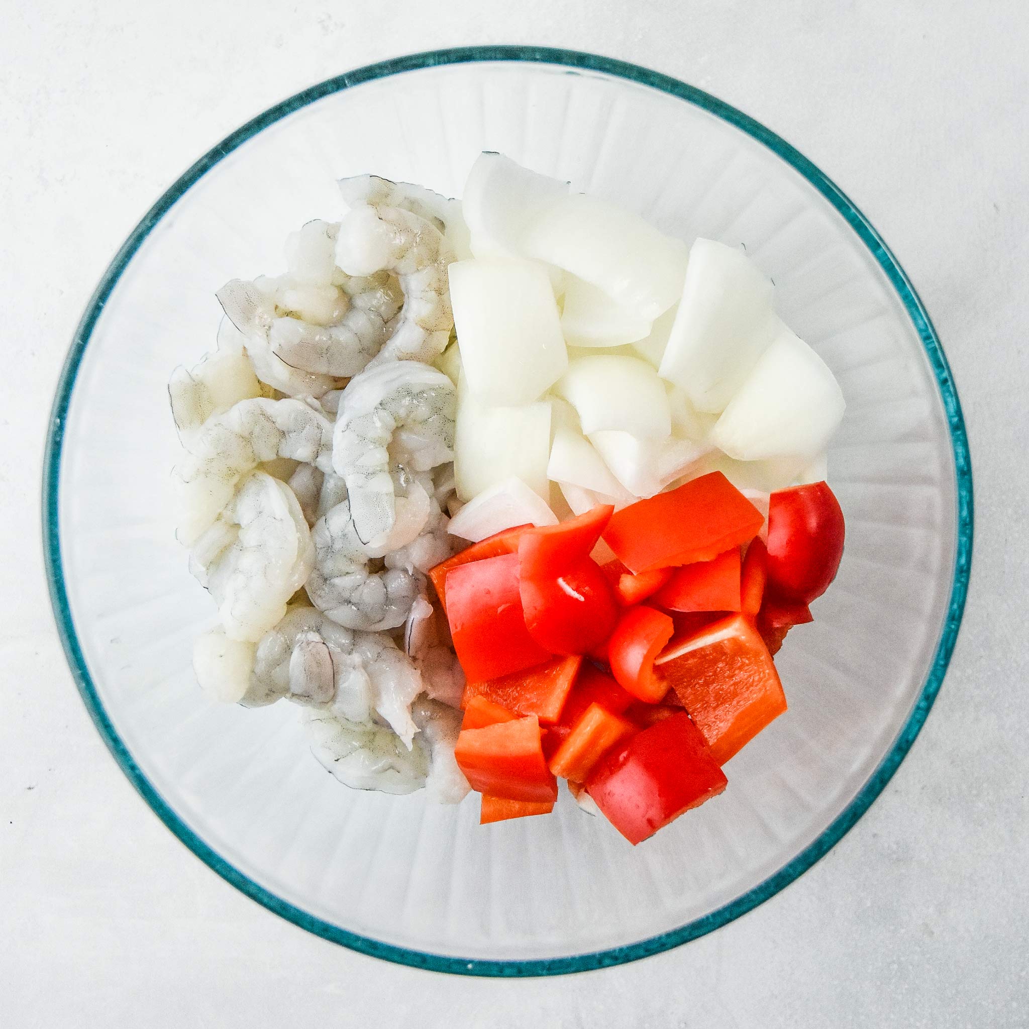 veggies and raw shrimp prepped in a bowl