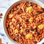 cinnamon raisin carrot salad in a white bowl