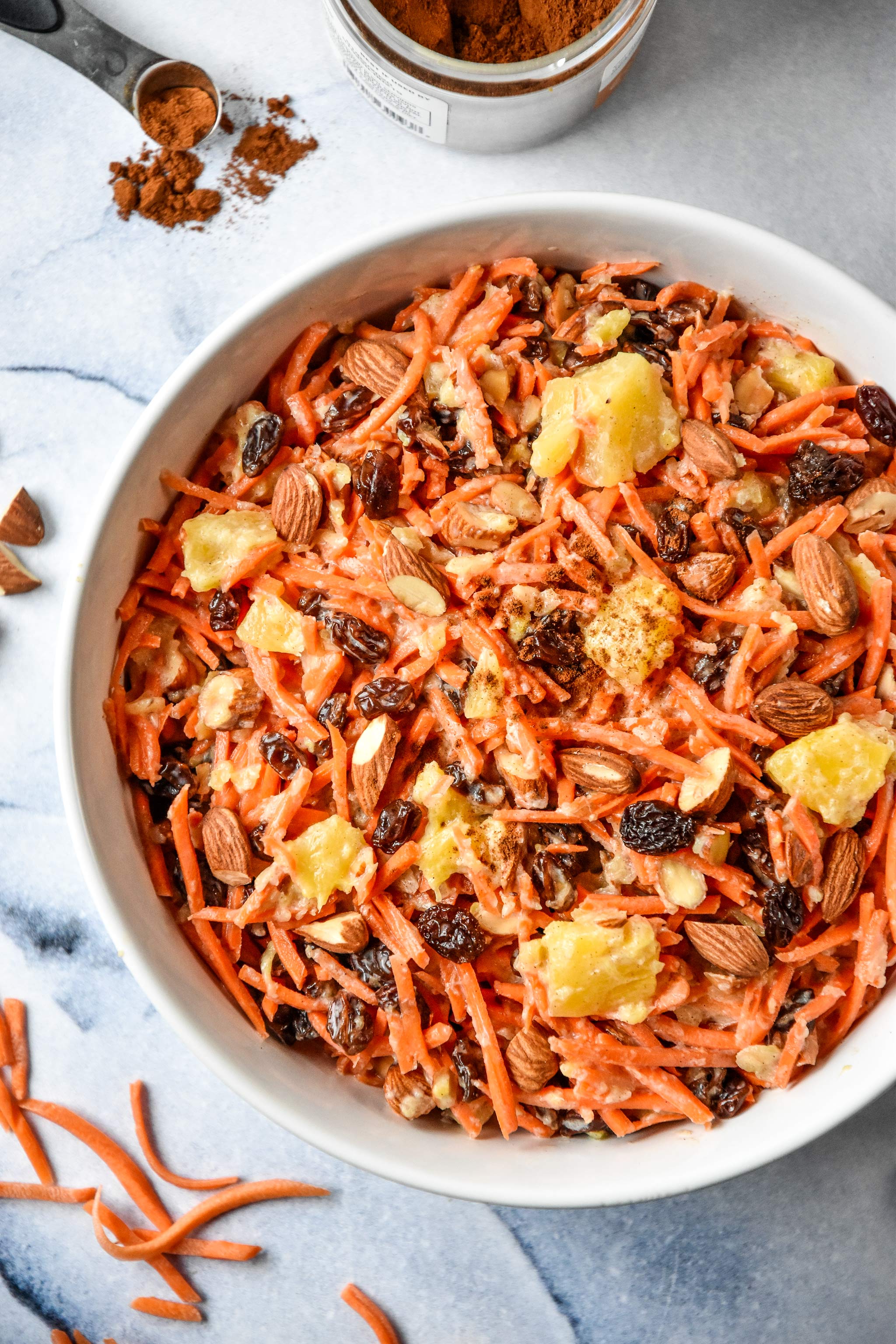 cinnamon raisin carrot salad in a white bowl