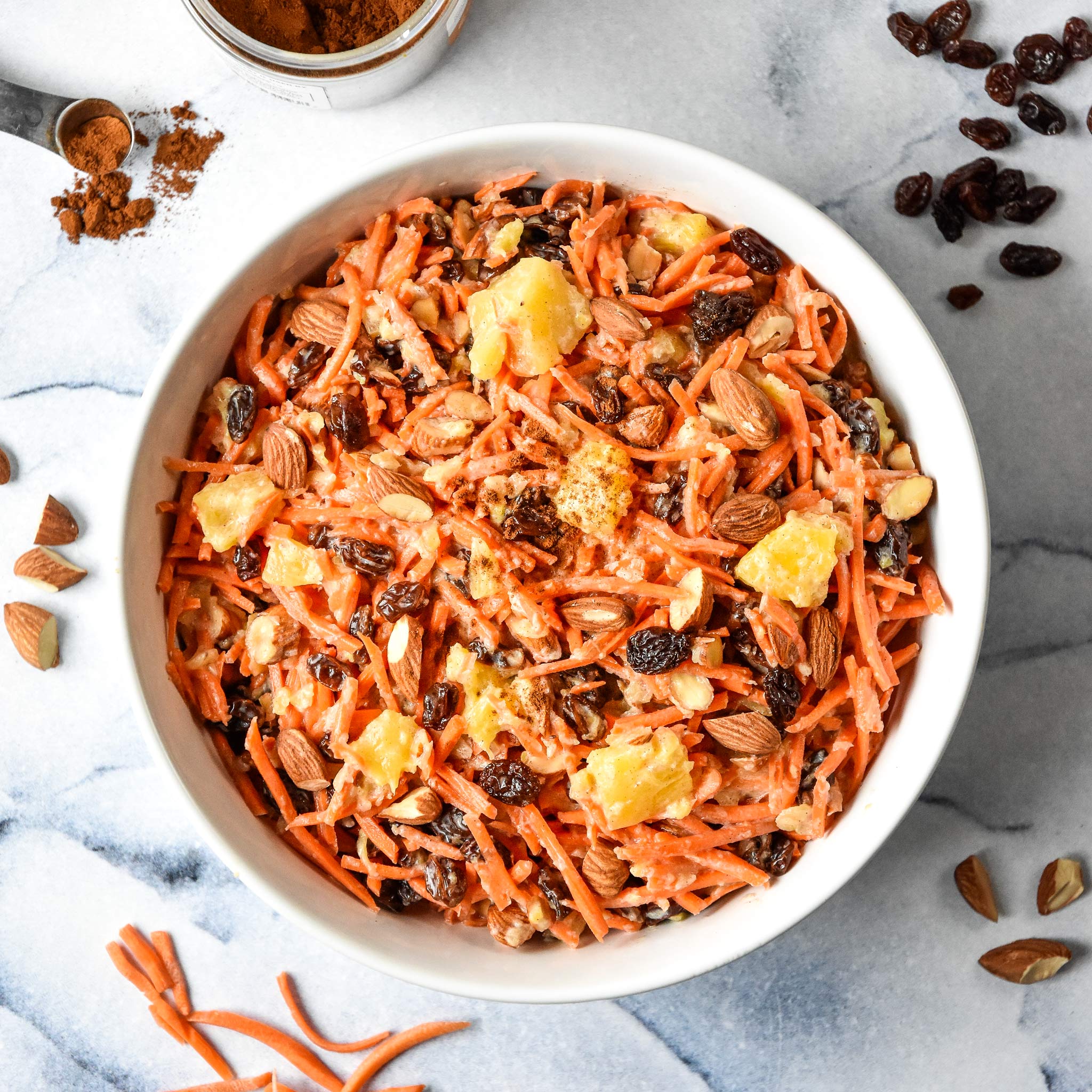 cinnamon raisin carrot salad in a white bowl from the top