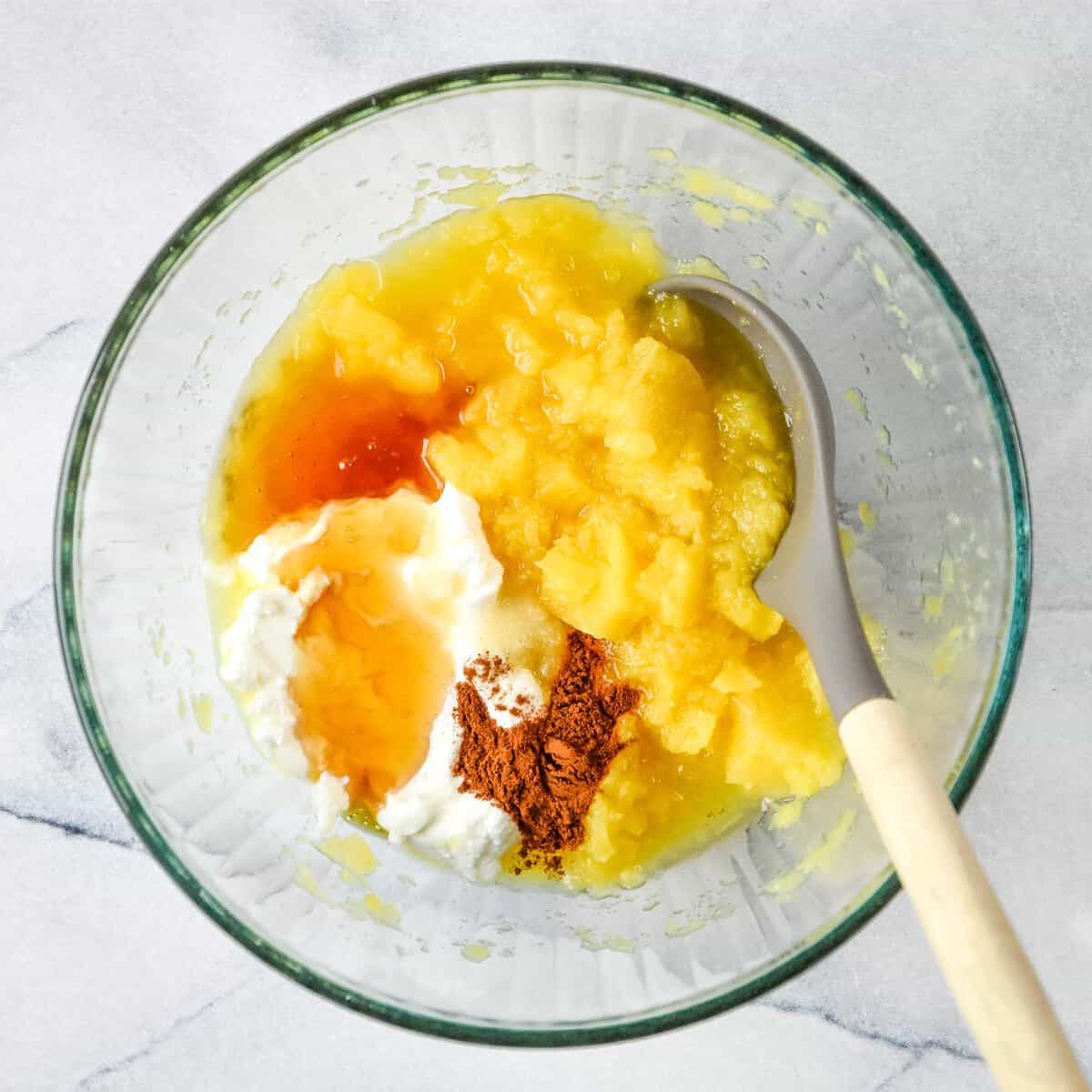 Wet ingredients in a bowl for the carrot raisin salad