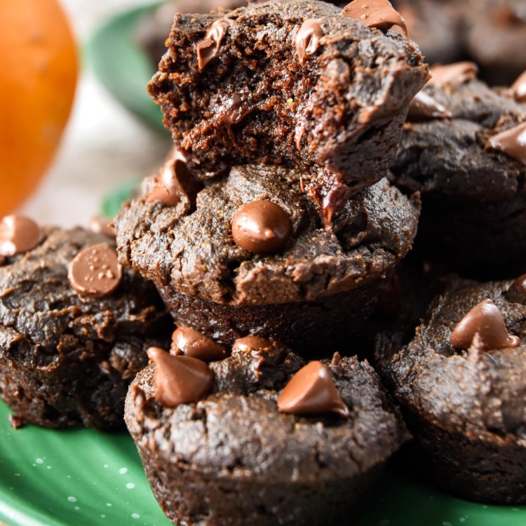 pumpkin spice brownie bites on a plate, one with a bite taken out