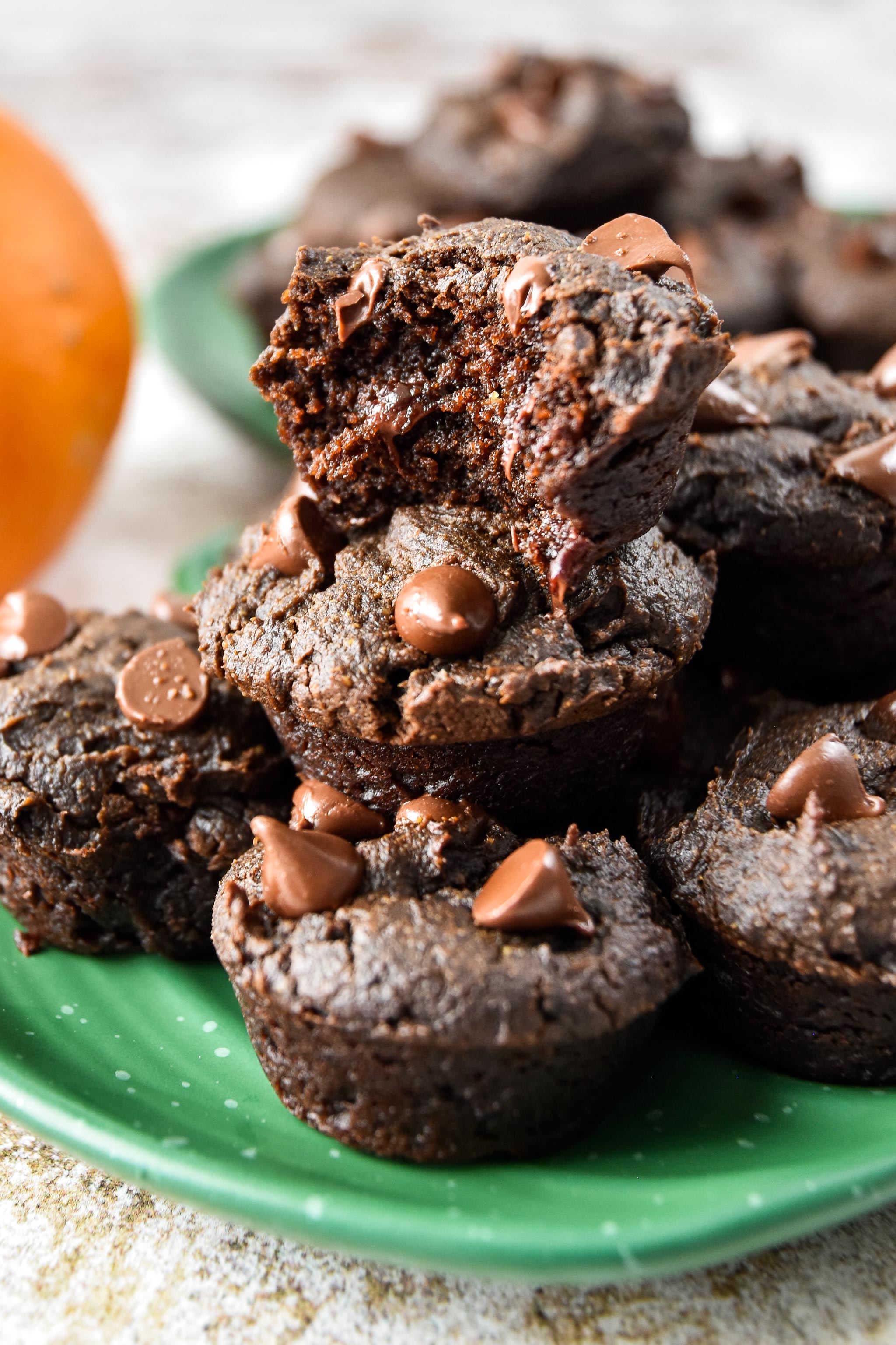pumpkin spice brownie bites on a plate, one with a bite taken out