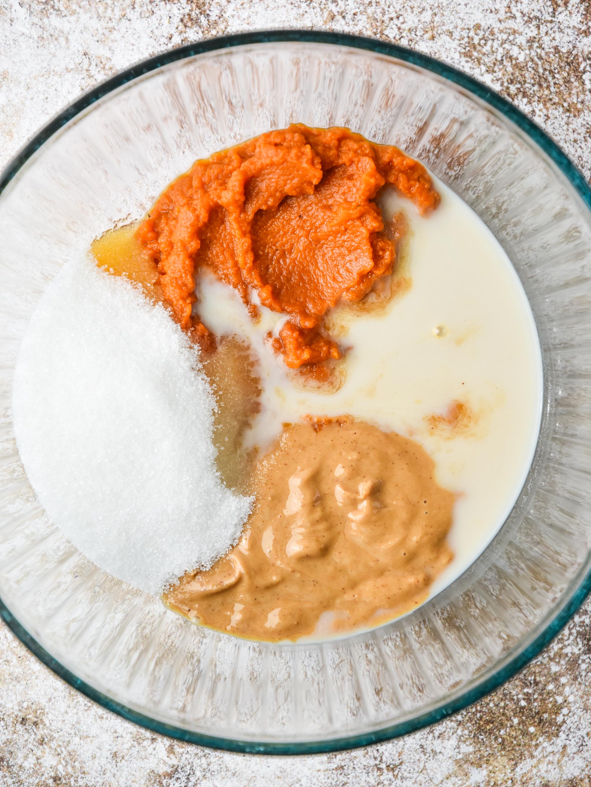wet ingredients in a bowl for the pumpkin spice brownie bites
