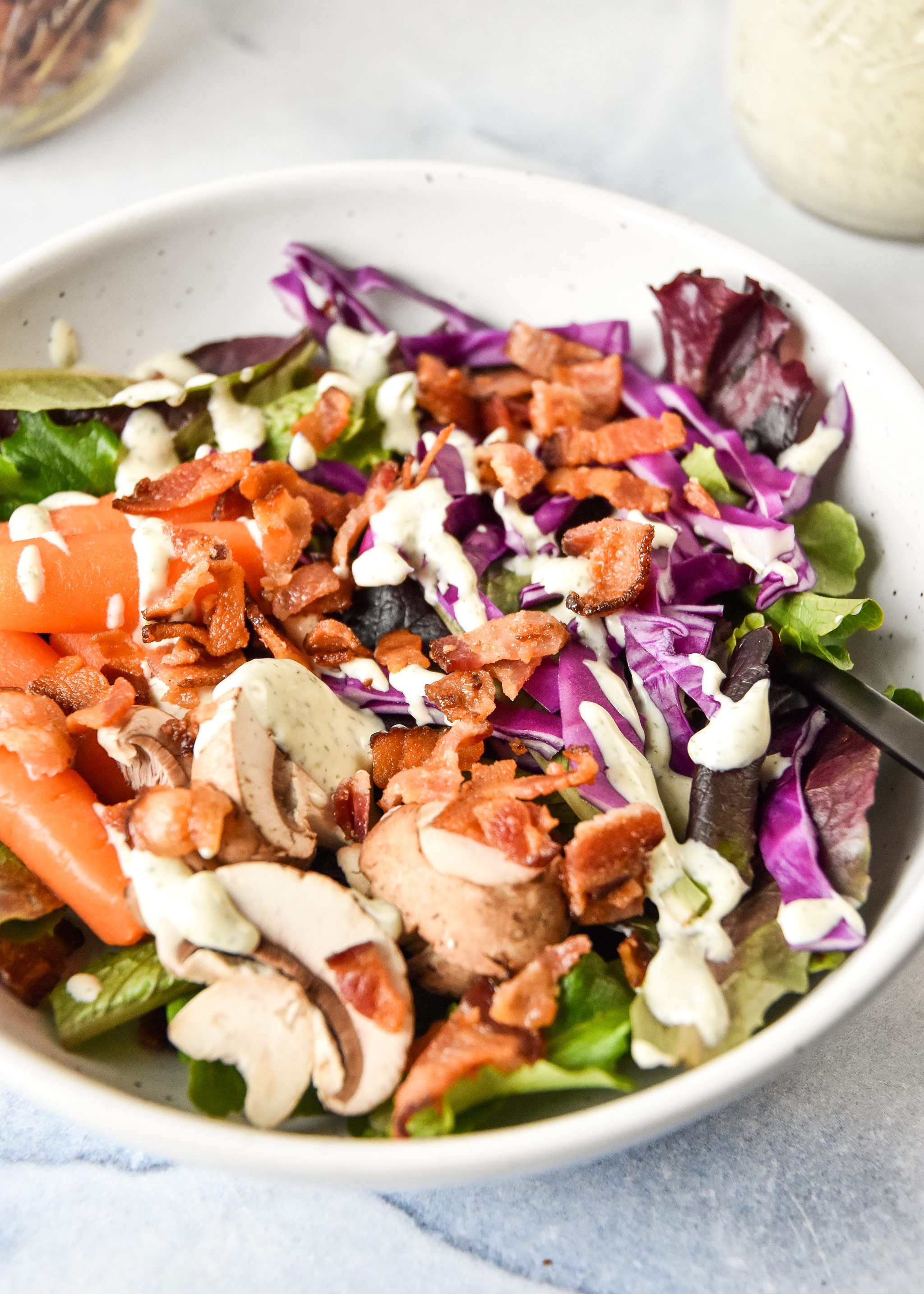 a salad with veggies and homemade bacon bits