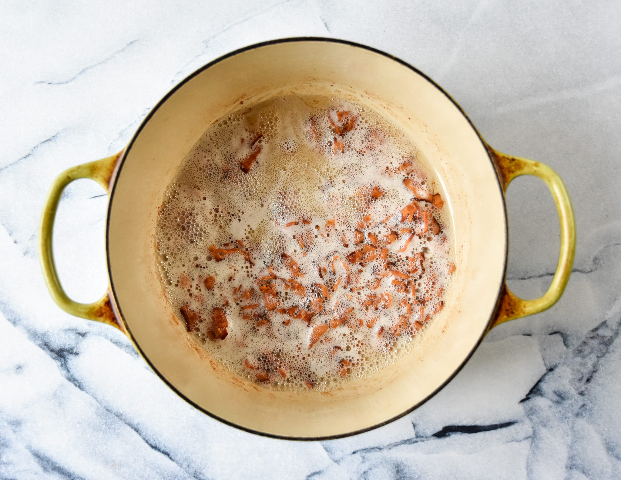 cooked bacon bits in a dutch oven