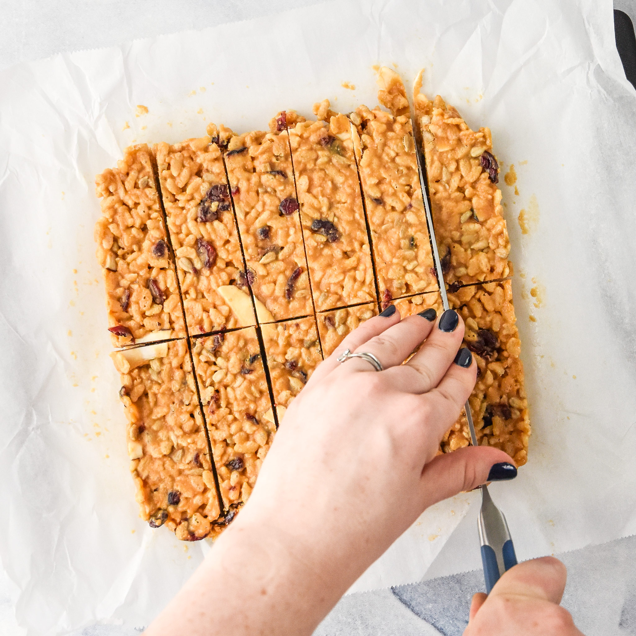 cutting up the peanut butter rice krispie breakfast bars
