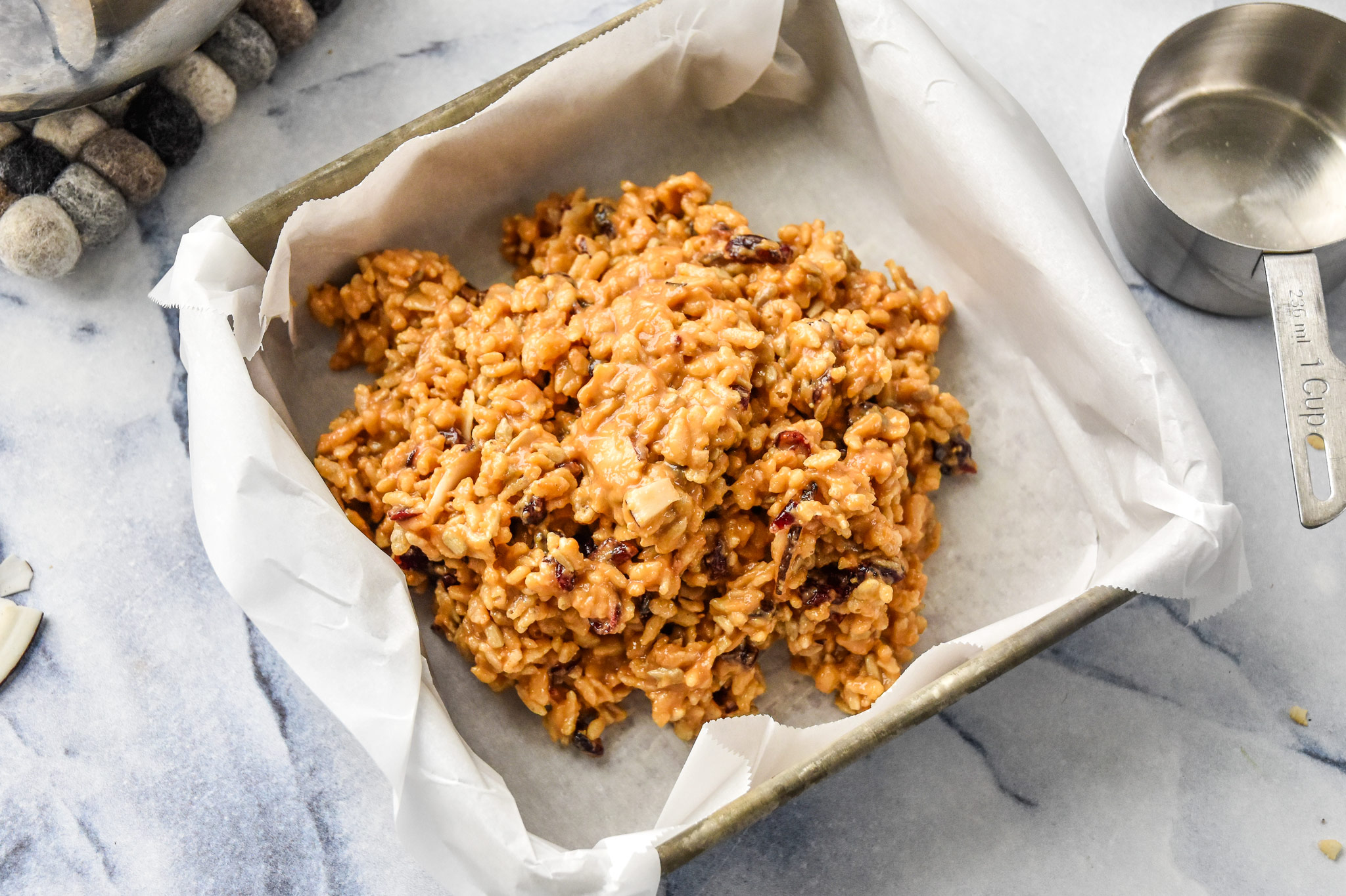preparing the peanut butter rice krispie breakfast bars in a baking pan