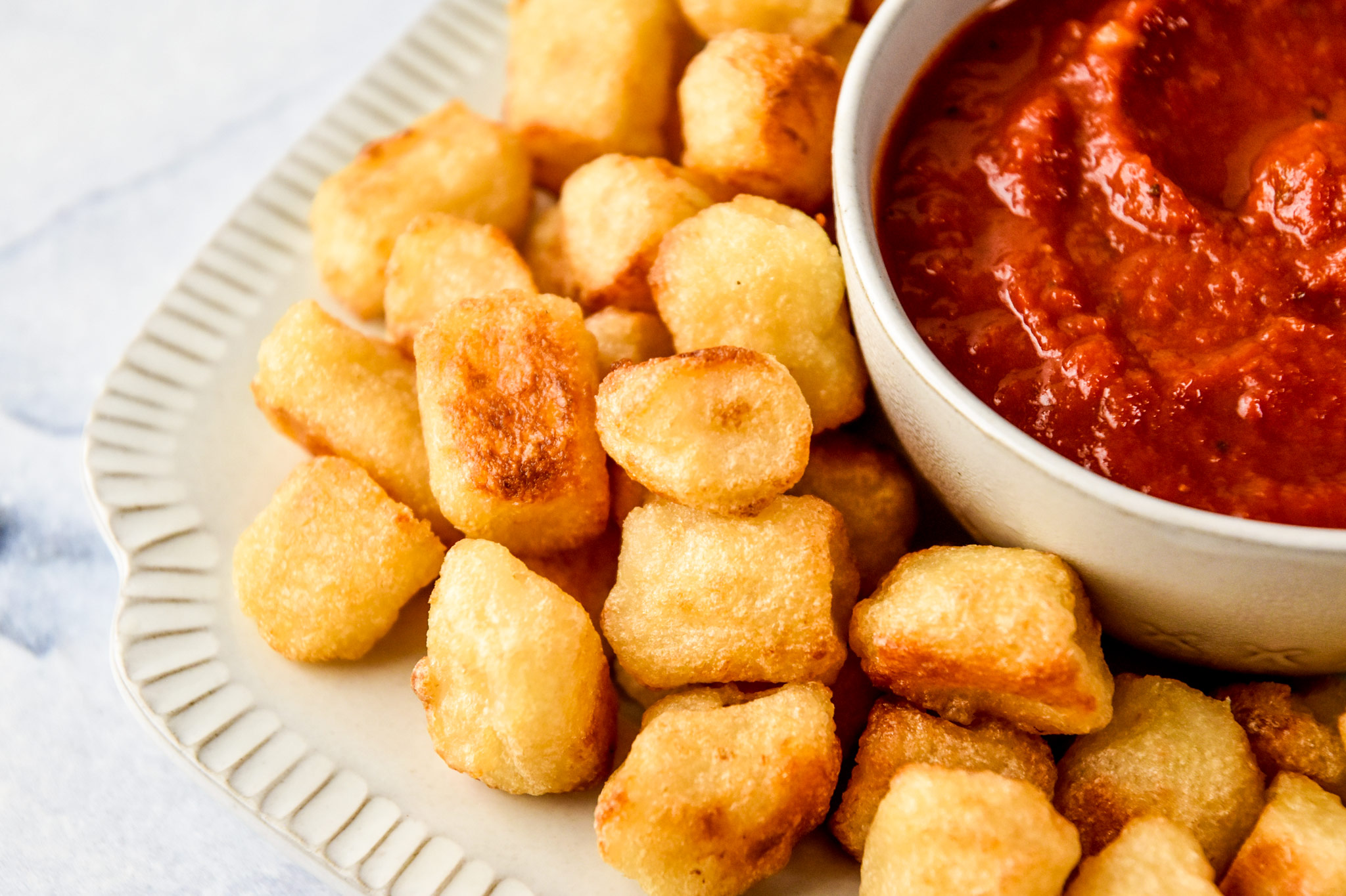 serving trader joe's cauliflower gnocchi with marinara sauce