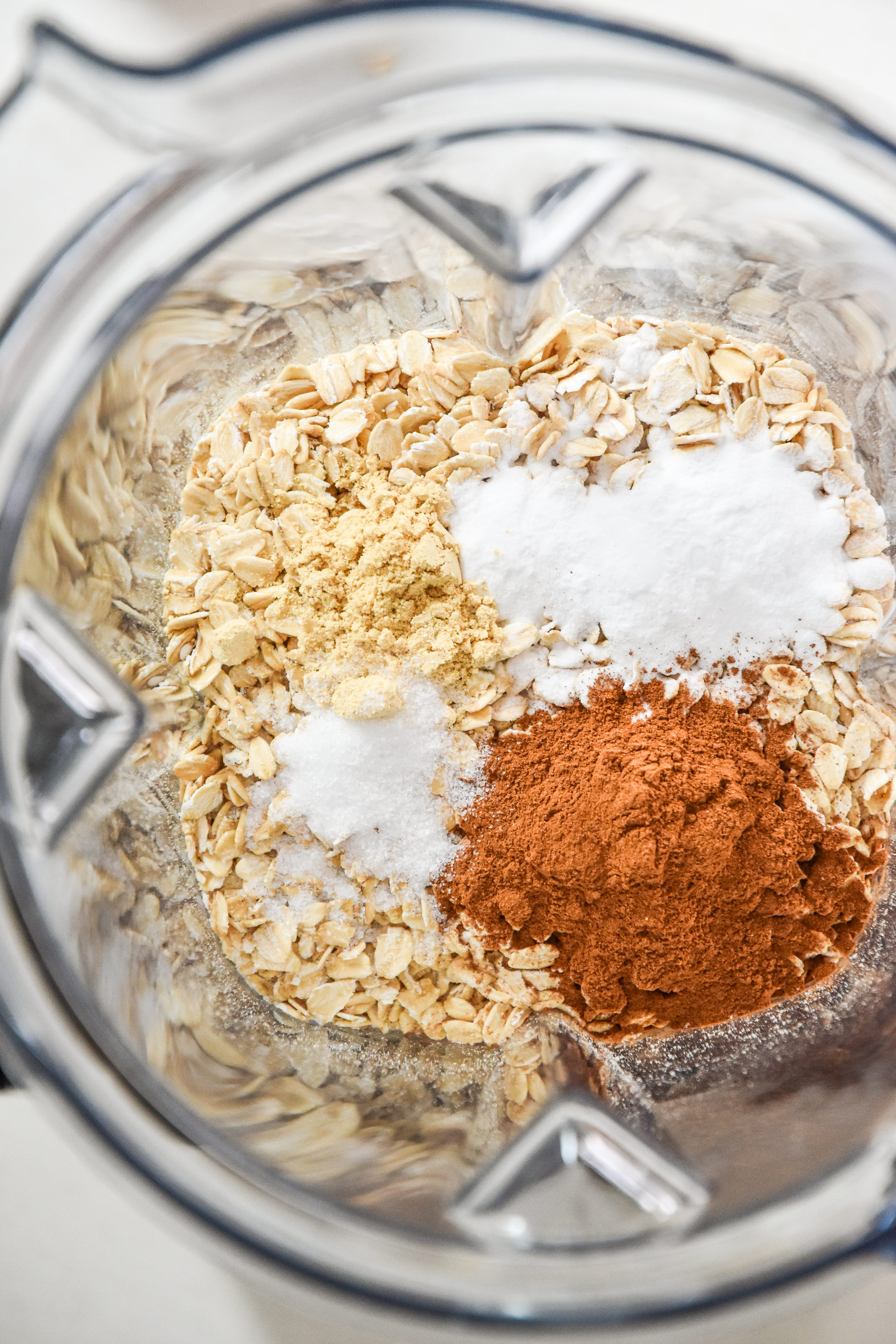 oats cinnamon ginger baking soda and salt about to be blended in a vitamix