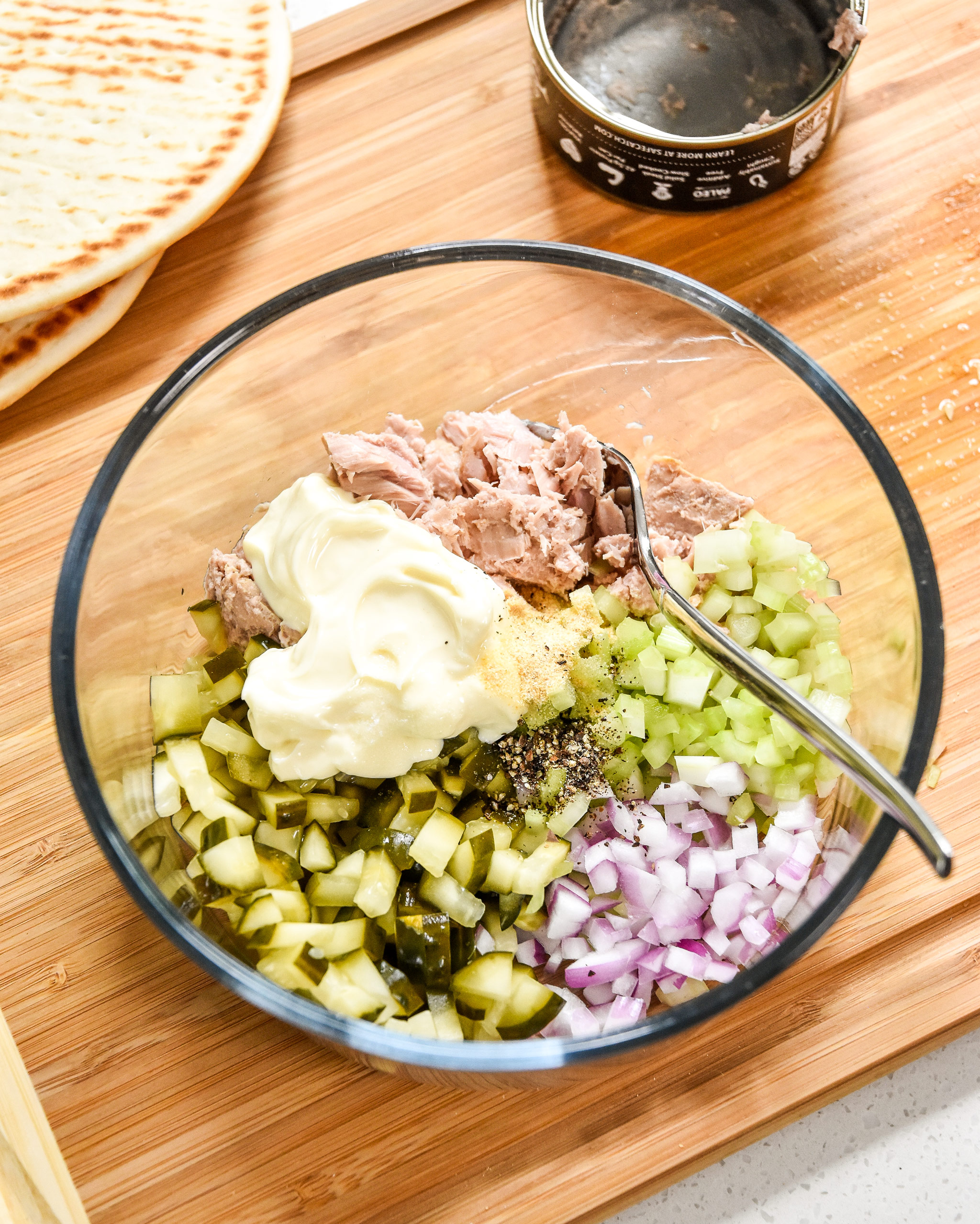 tuna salad ingredients in a bowl about to be mixed into tuna salad