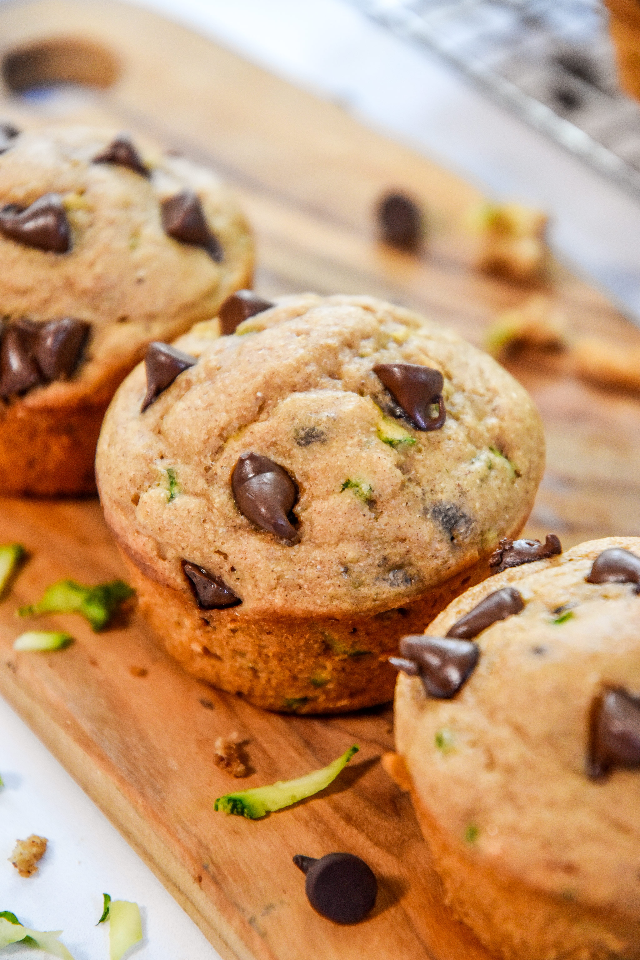 golden brown baked pancake mix zucchini muffins on a cutting board.
