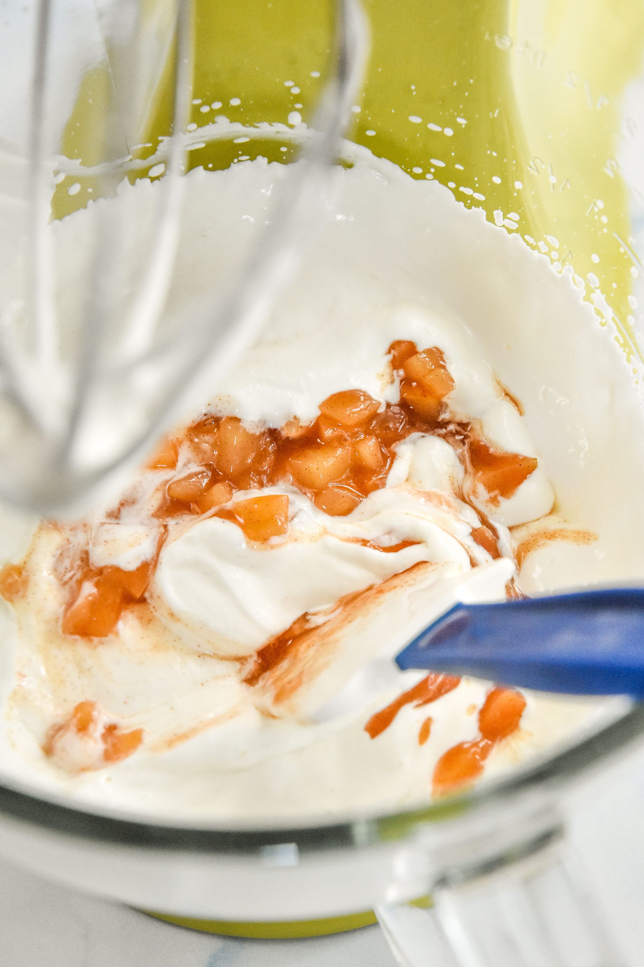 adding cooked apples to the whipped greek yogurt.