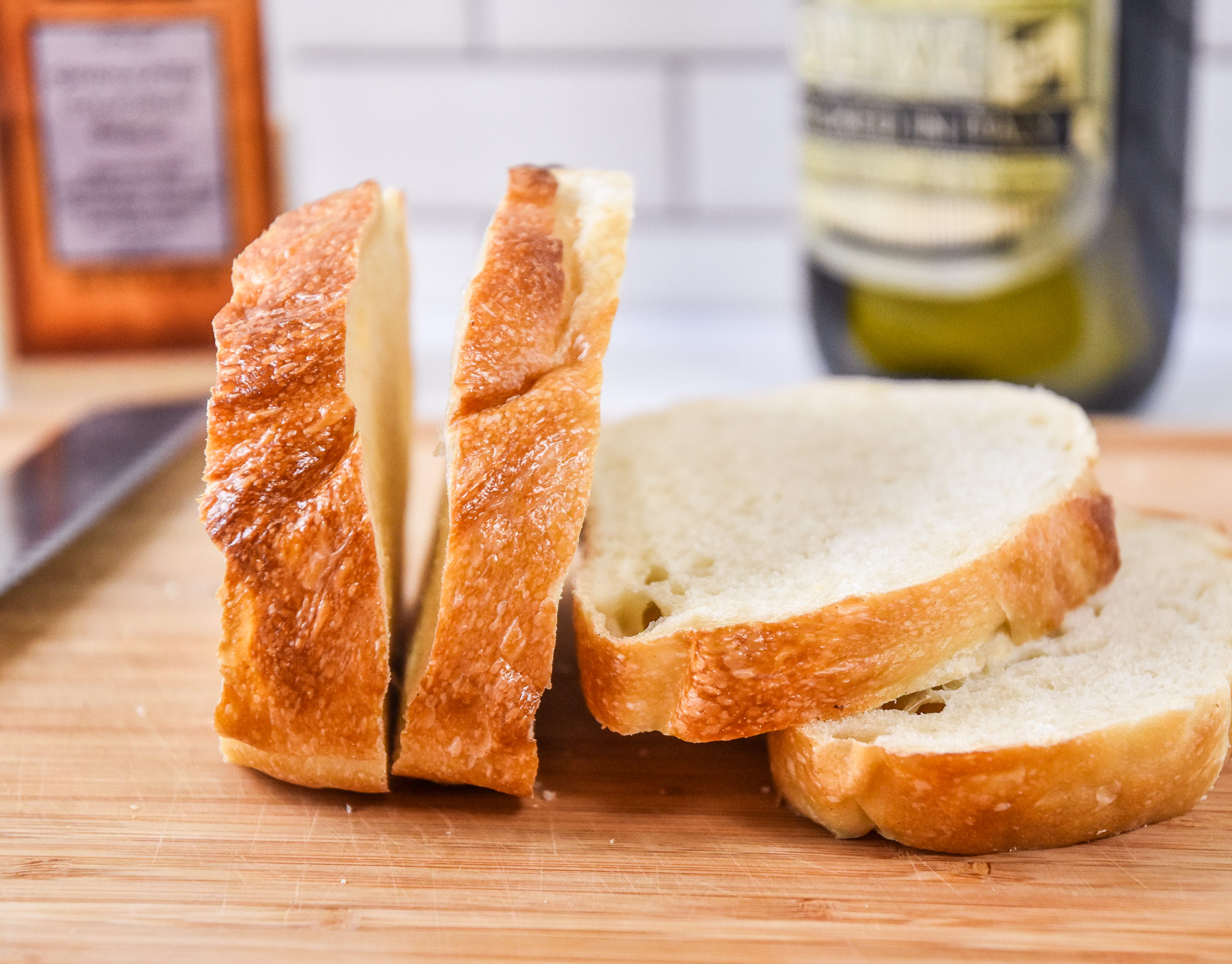 four slices of sourdough bread on a cutting board.