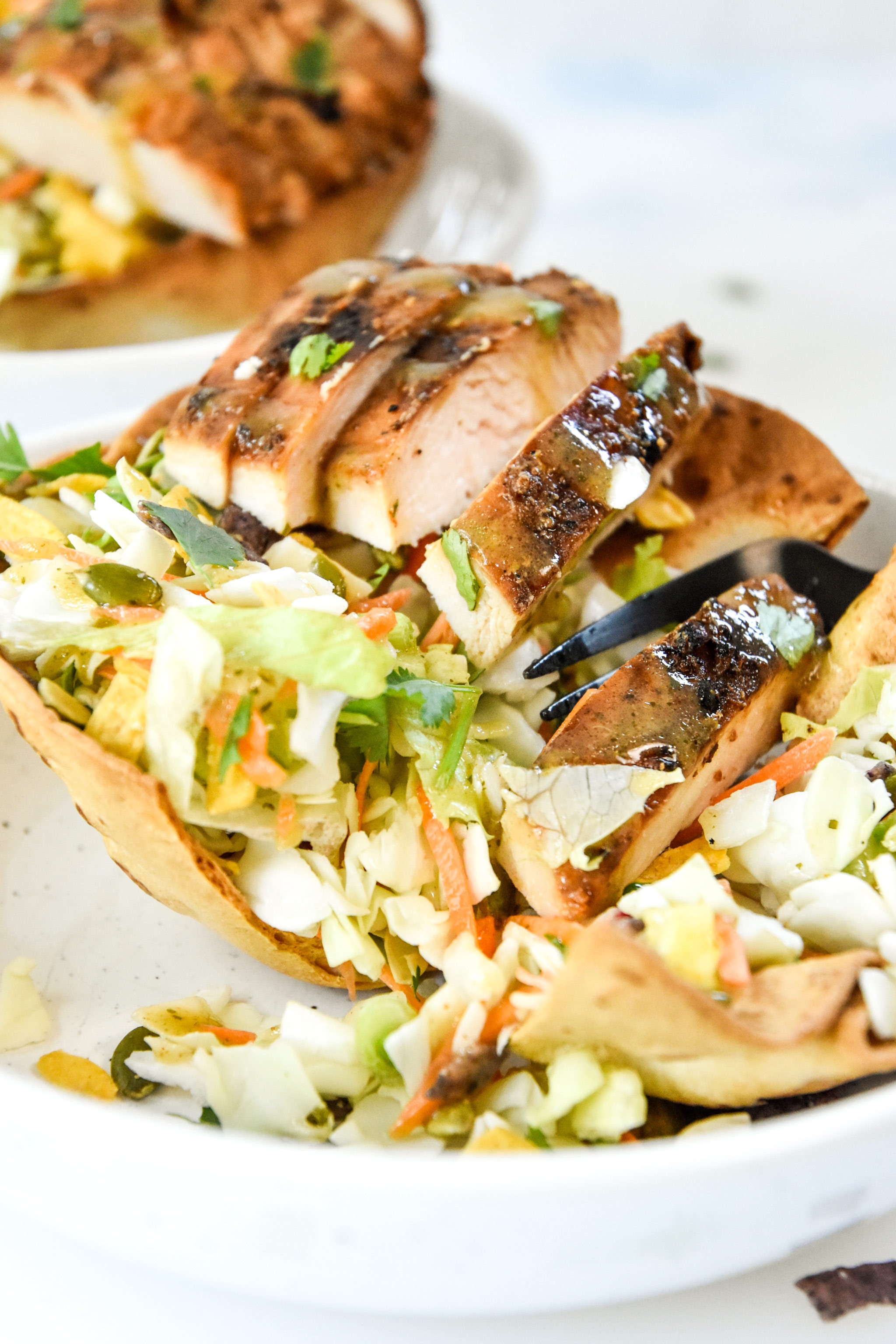 delicious taco salad with chicken in an air fryer flour tortilla bowl.