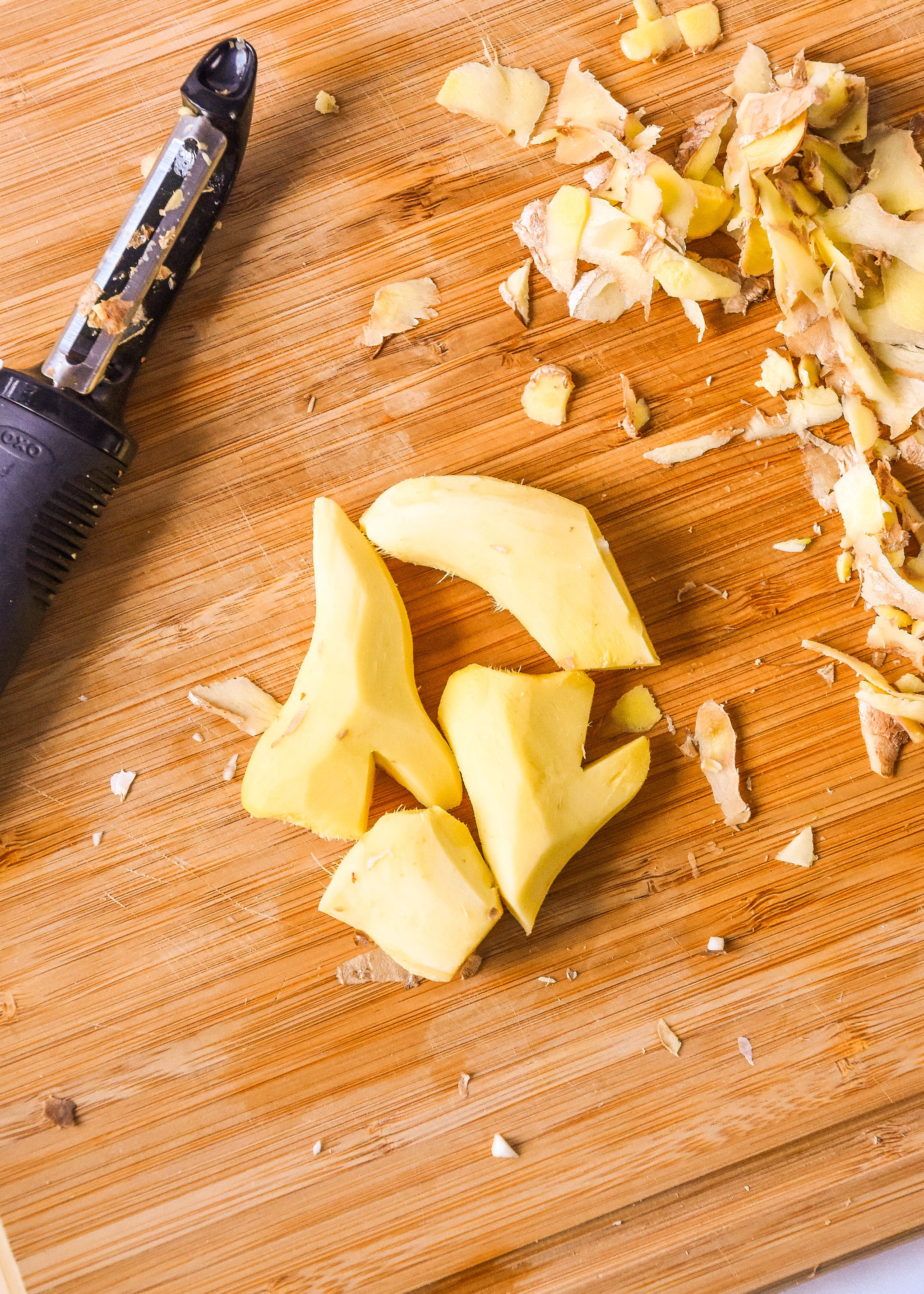 fresh peeled ginger on a cutting board.