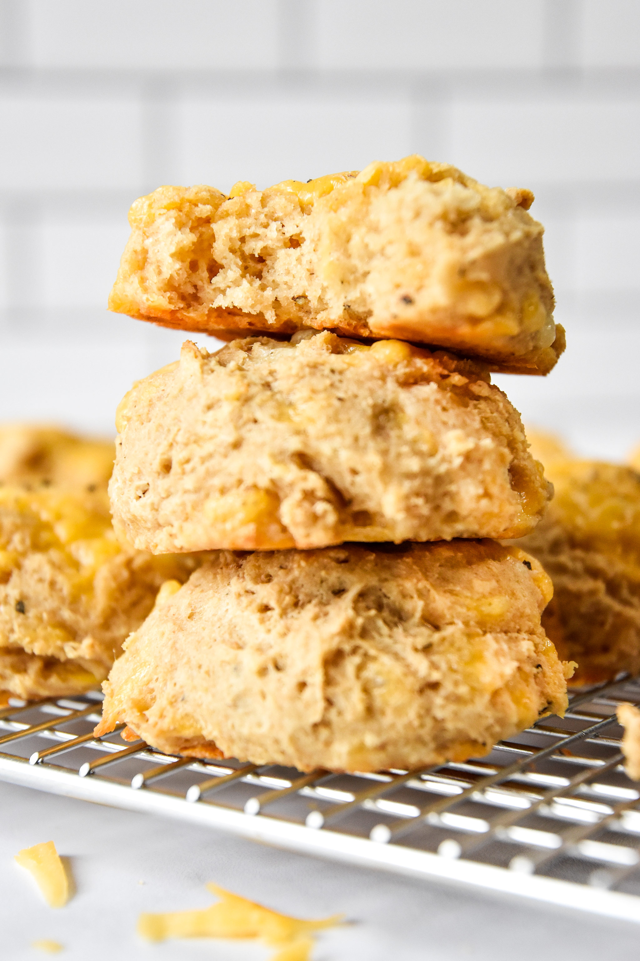 stacked biscuits one with a bite out of it.