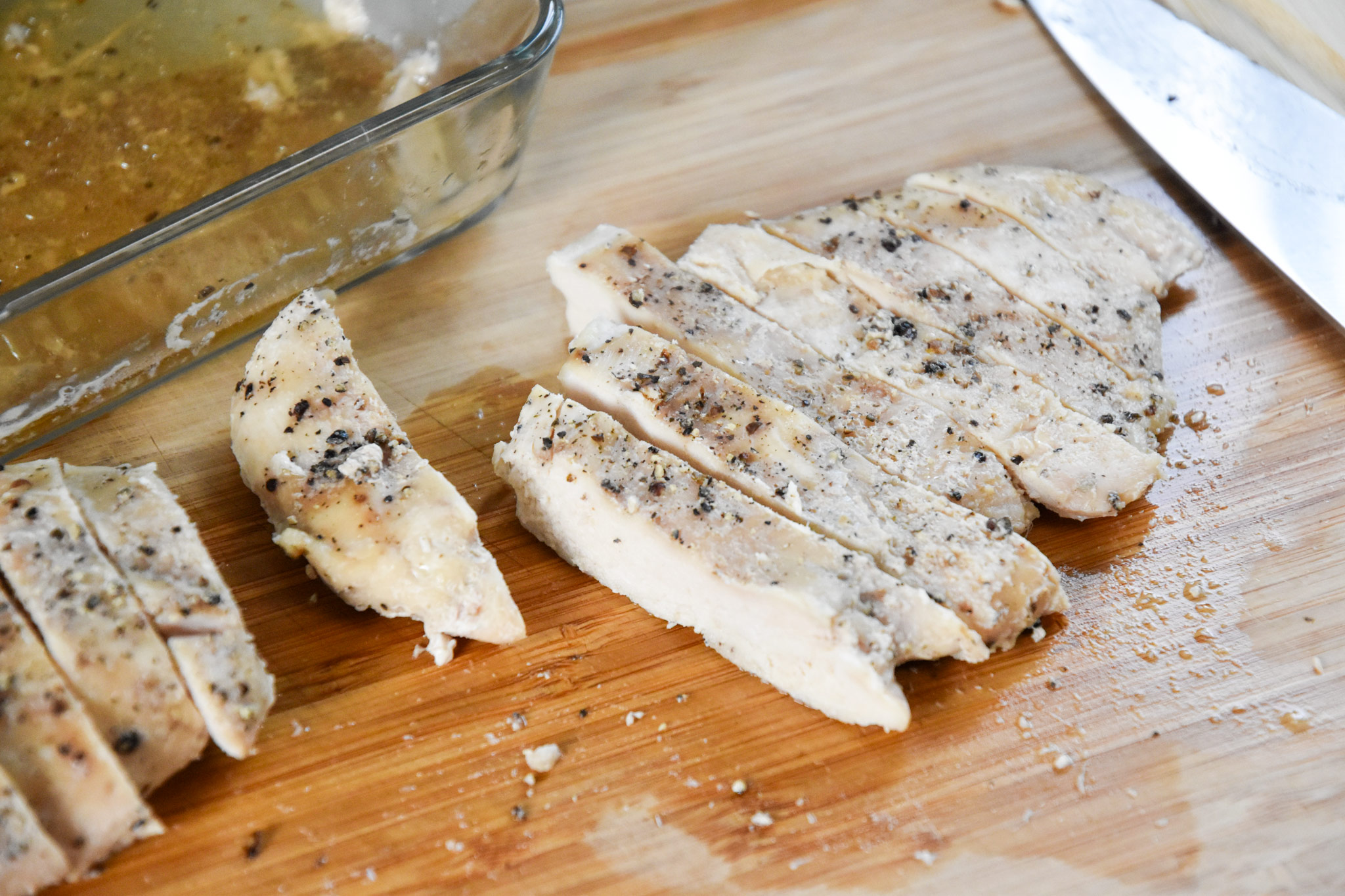 chicken cooked in the hotlogic mini cut up on a cutting board.