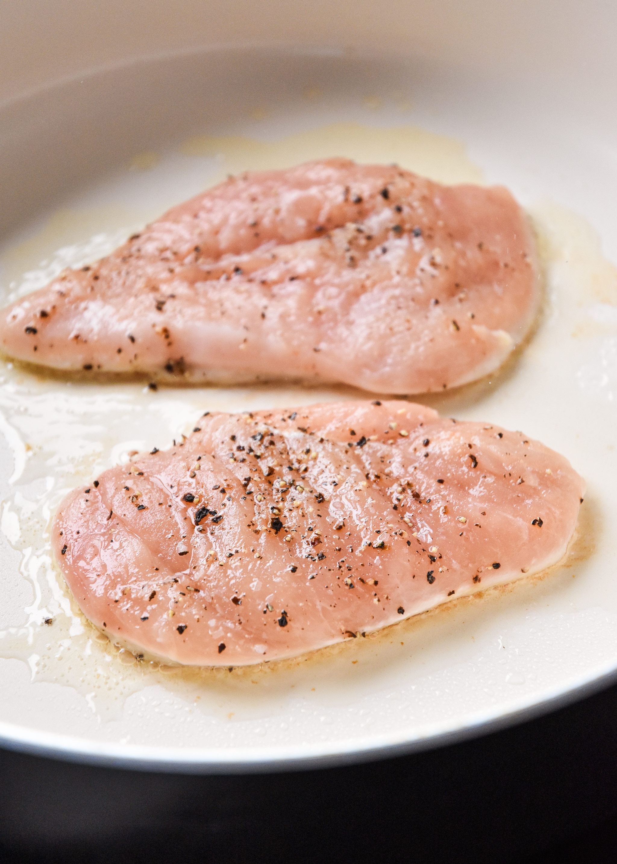 cooking seasoned chicken breast in avocado oil.