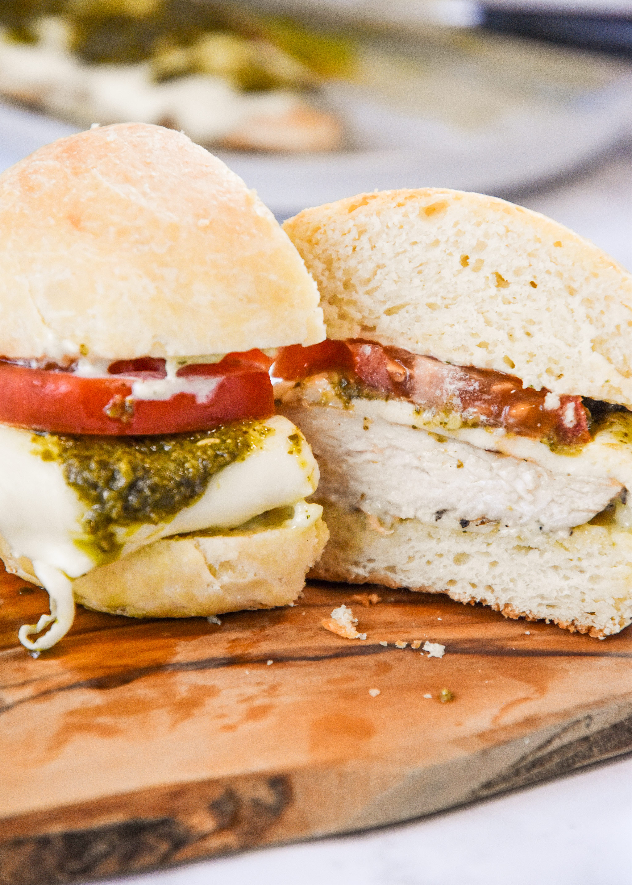 pesto chicken mozzarella sandwich cut in half.