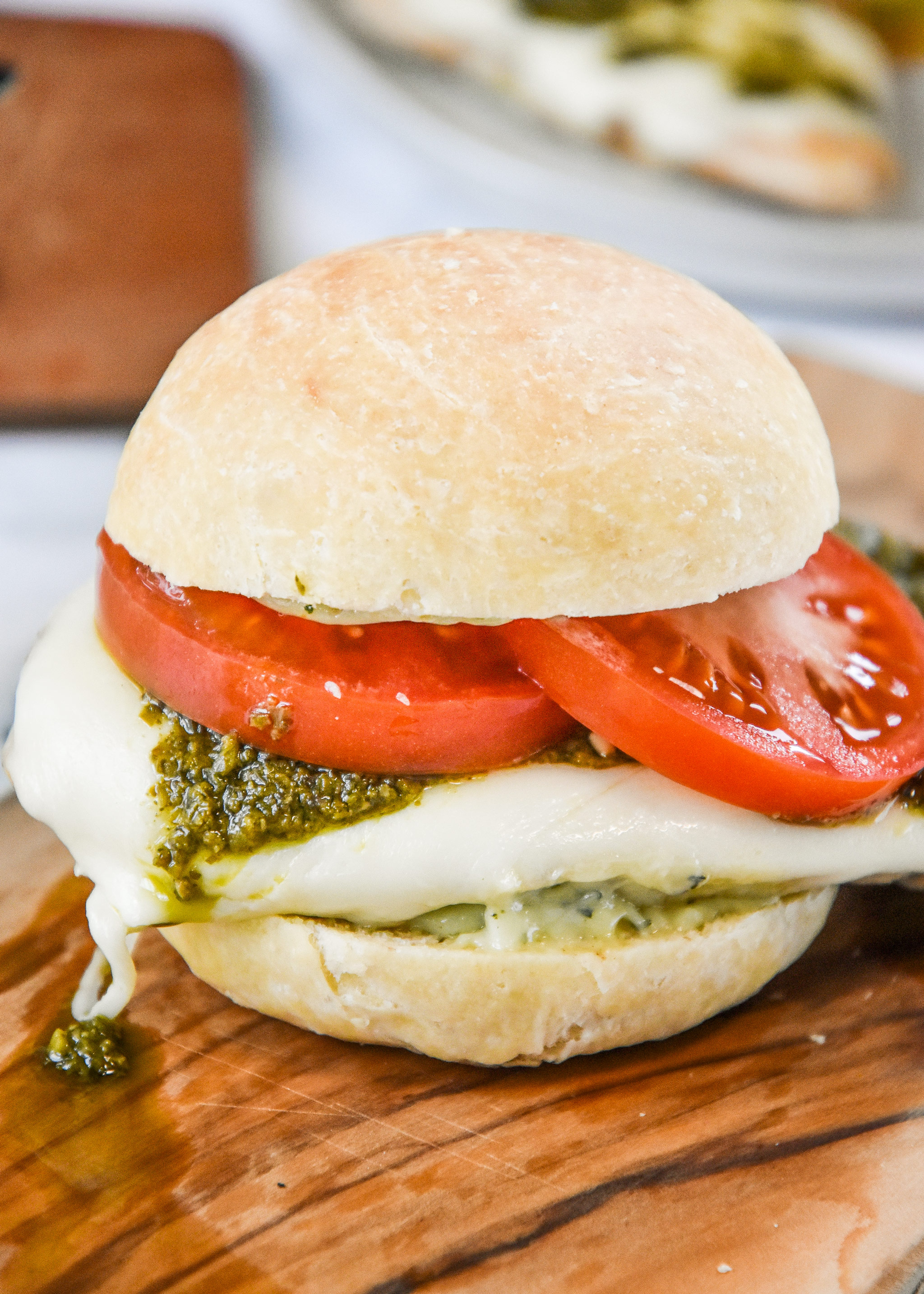 pesto chicken mozzarella sandwich just assembled with tomatoes.