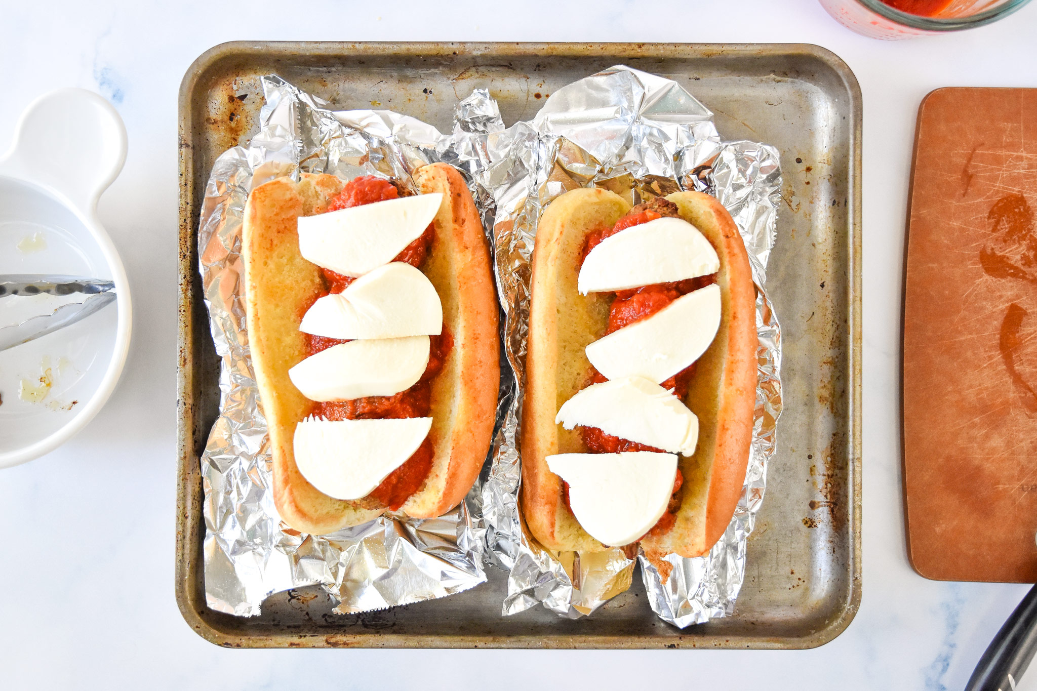 assembled meatball sub sandwiches about to go into the oven.