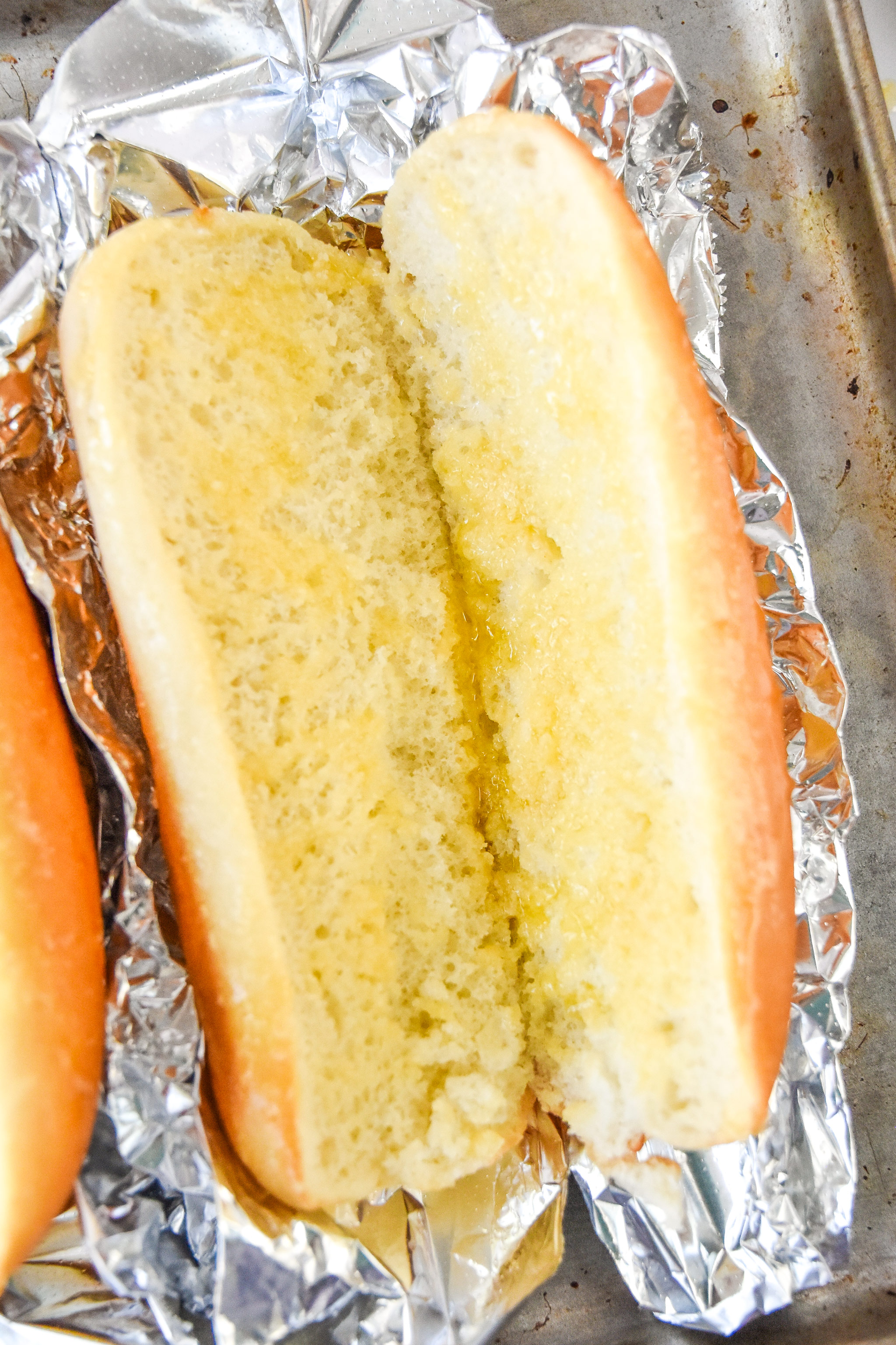 buttered hoagie roll on aluminum foil before toasting.