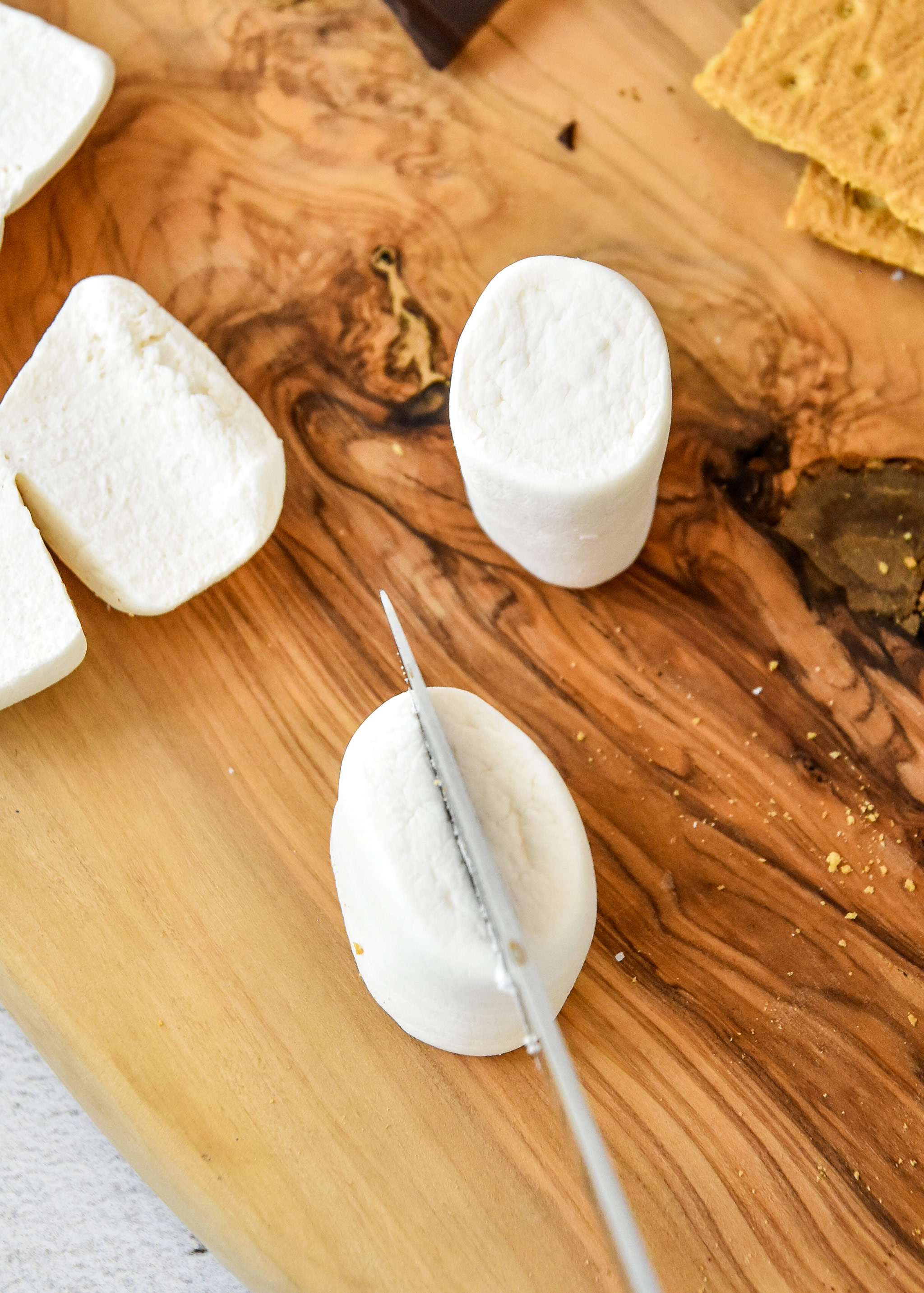 cutting marshmallow in half for air fryer s'mores.