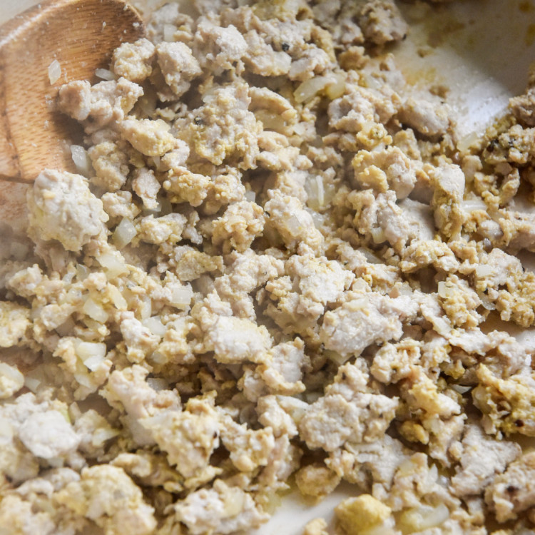 cooked ground turkey mustard mixture with a wooden spoon.