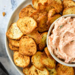 air fryer everything bagel chips on a plate with smoked salmon dip.