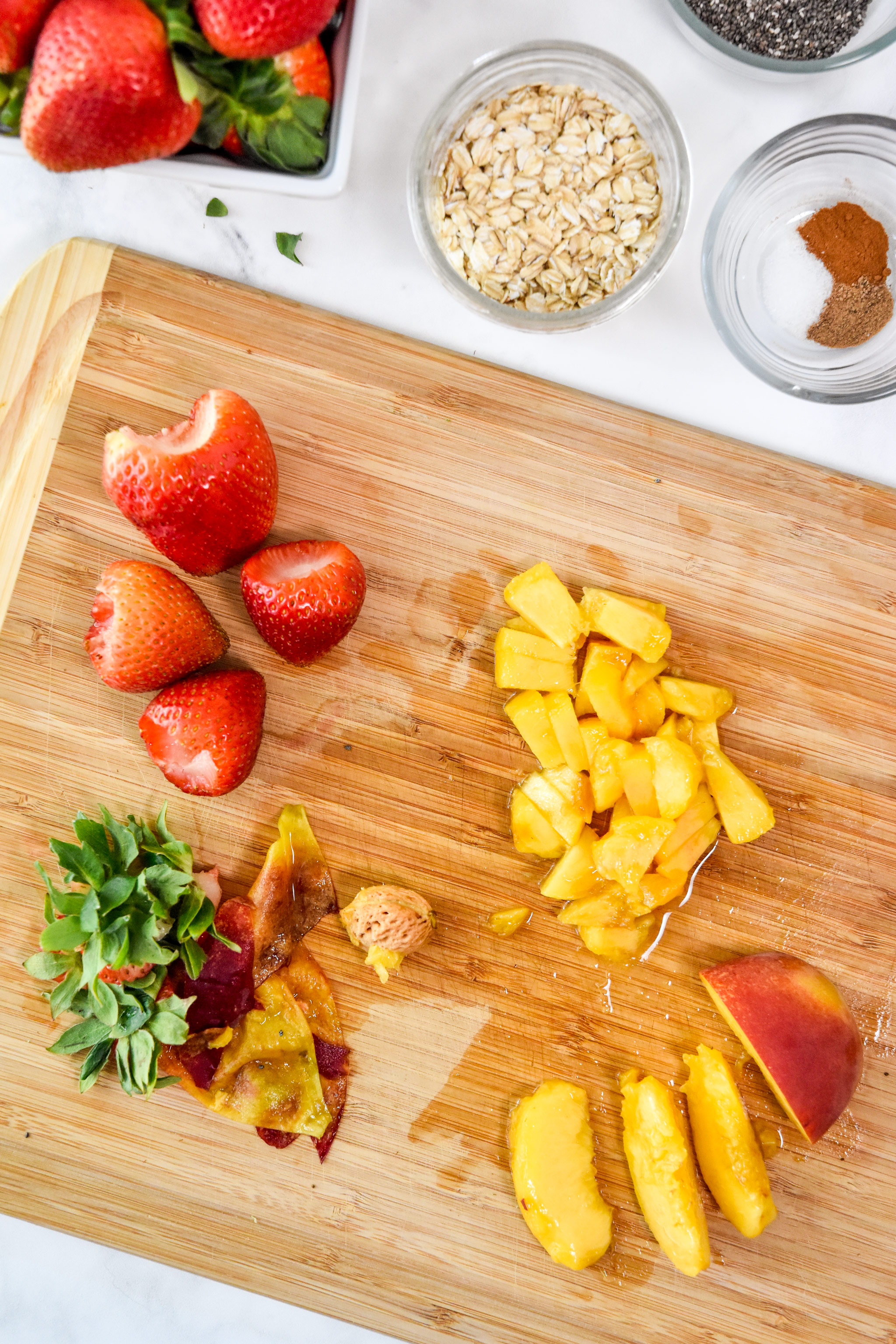 cutting fruit for the strawberry peach overnight oats.