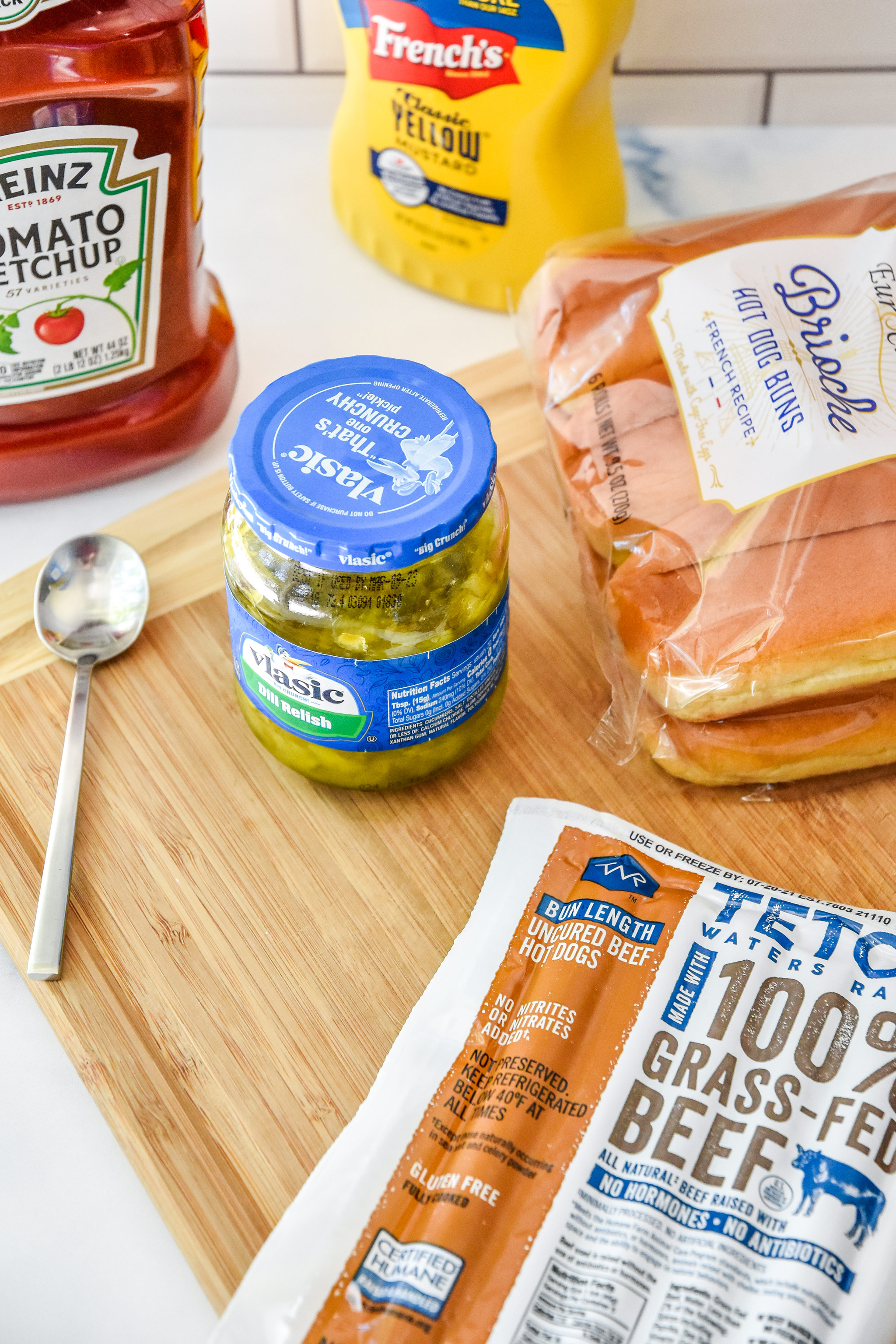 hot dog ingredients including ketchup, mustard, relish, hot dogs.