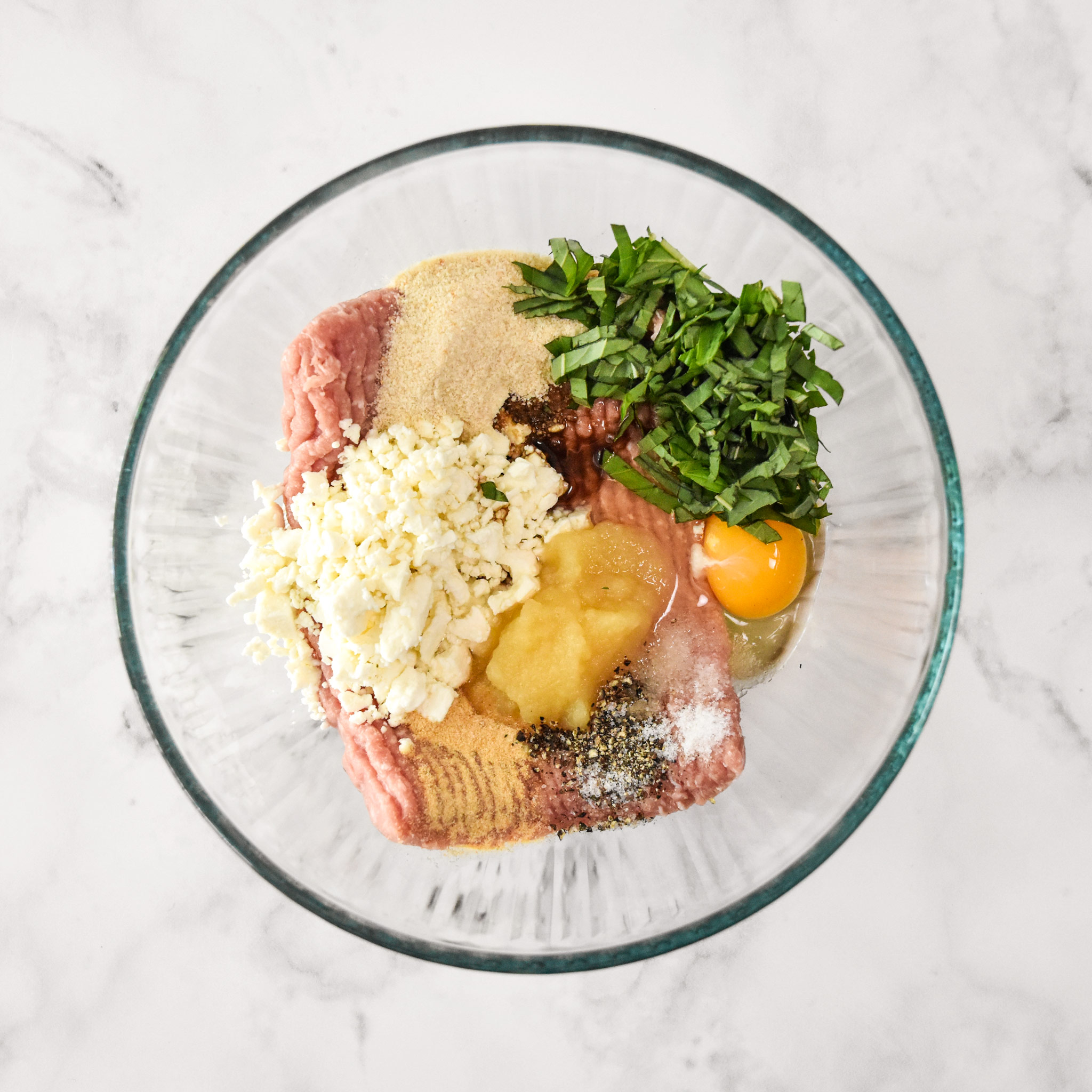 ingredients in a glass bowl for the turkey burgers.