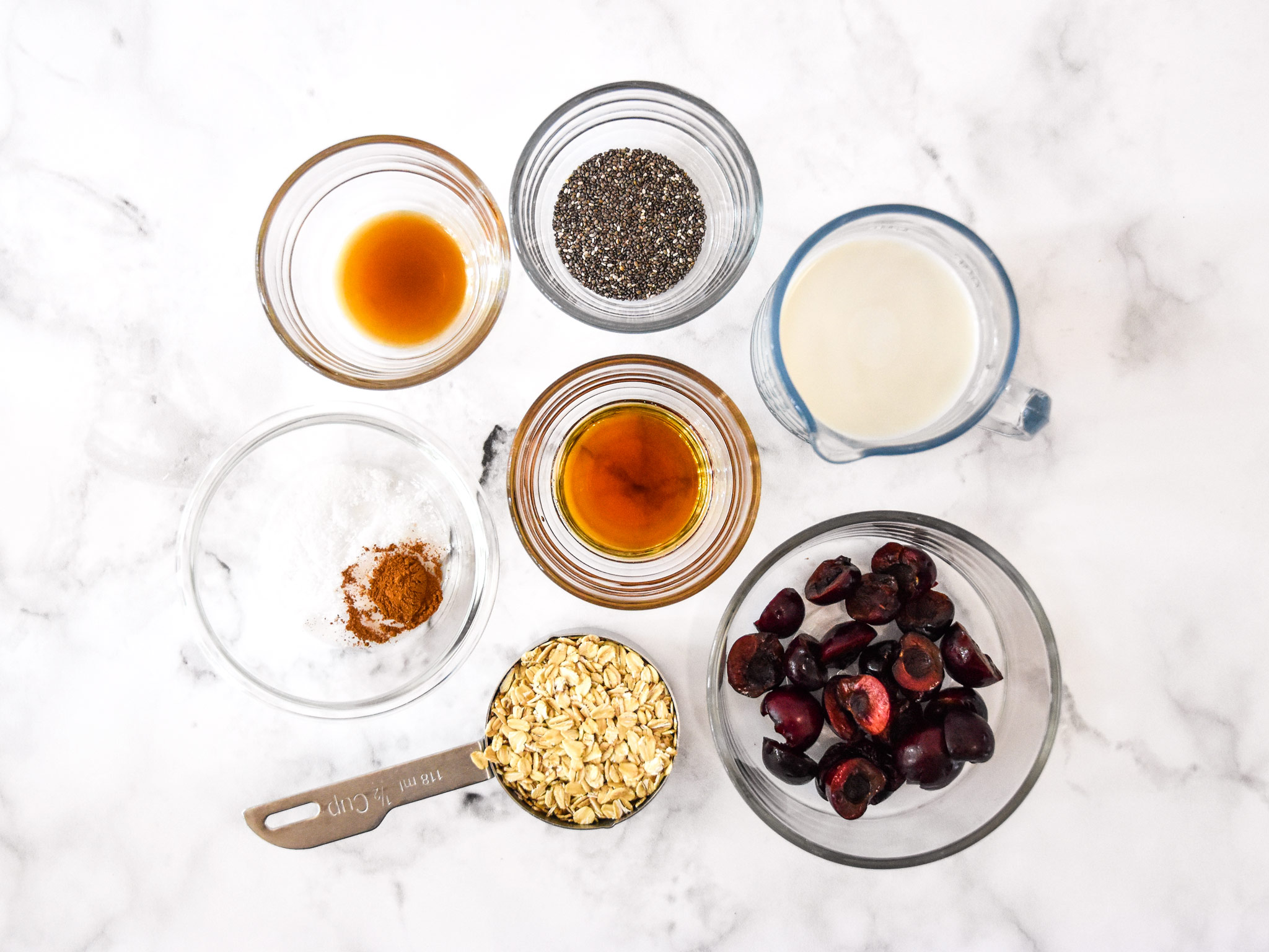 ingredients in bowls for the cherry vanilla overnight oats.