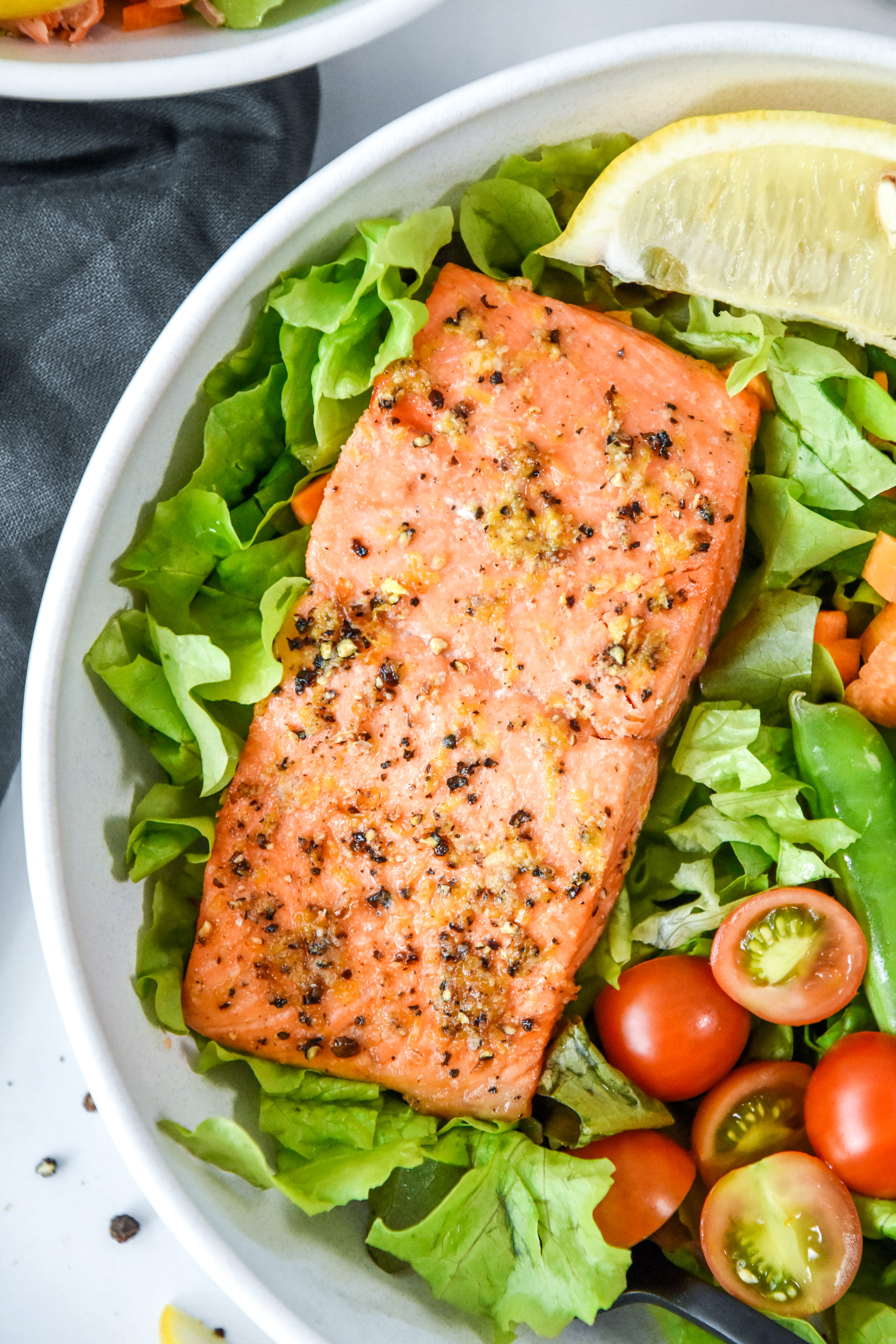 air fryer lemon pepper salmon on a salad.