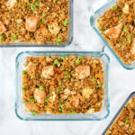 meal prep chicken quinoa fried rice bowls in rectangular pyrex glass containers.