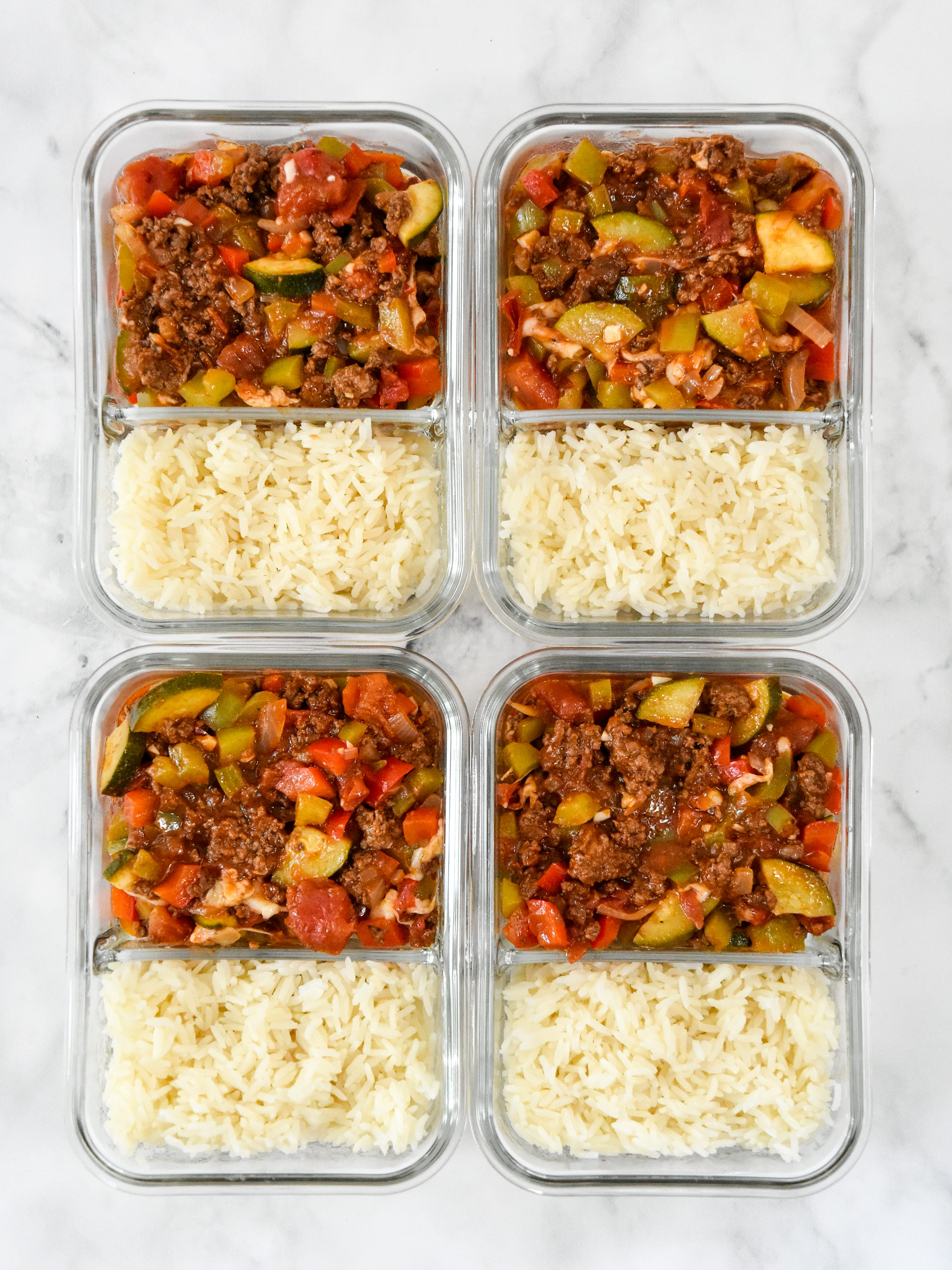 glass containers full of meal prep unstuffed pepper bowls mixture.