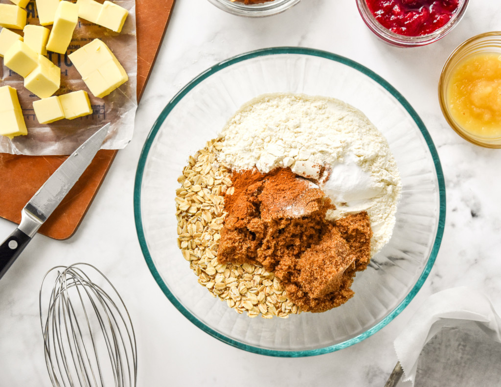 dry ingredients in the glass mixing bowl for the cranberry pretzel oat crumble bars.