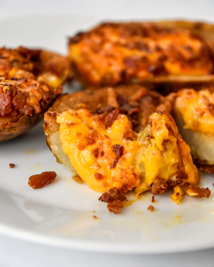cooked frozen potato skin cut in half with cheese coming out.